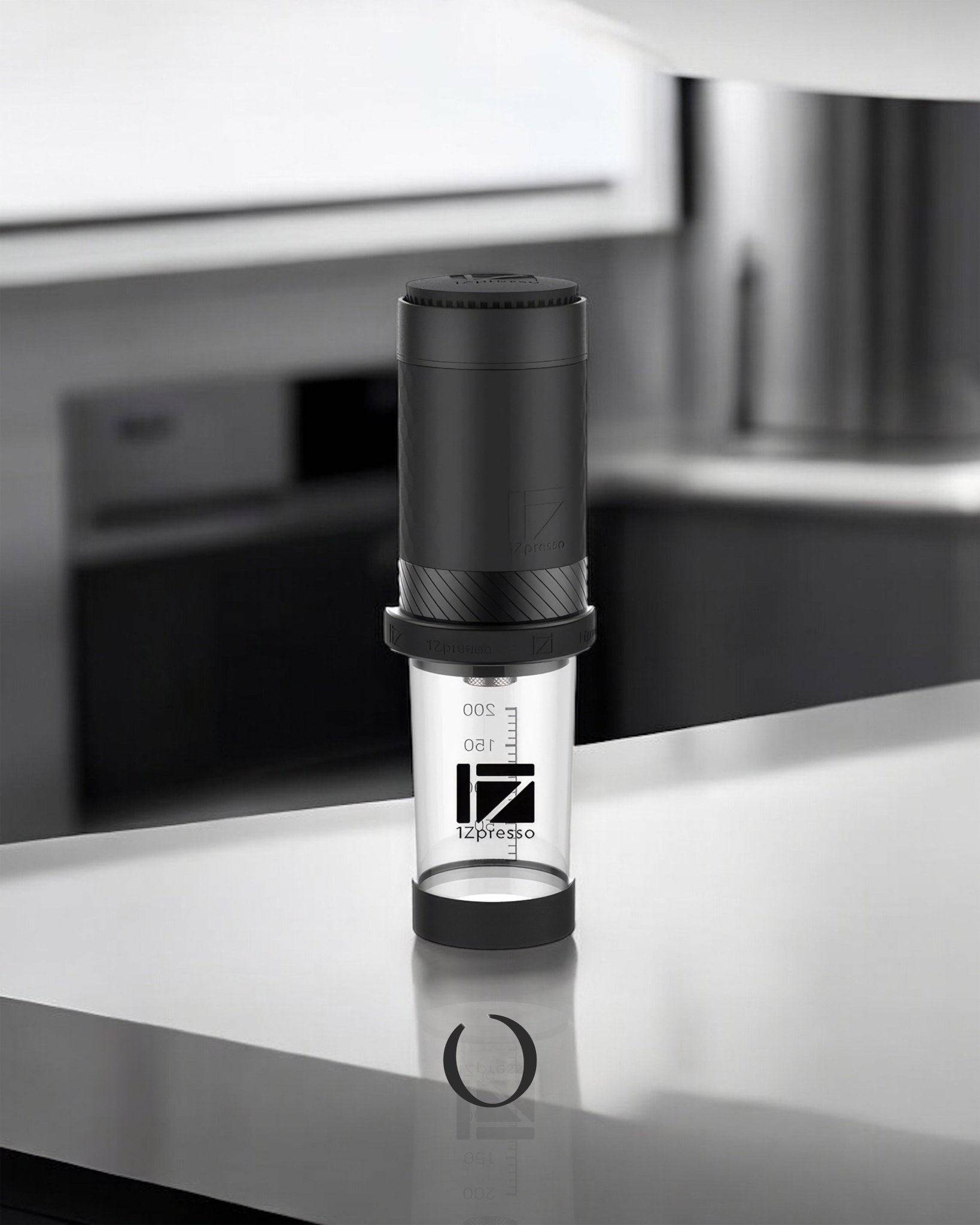 1Zpresso Y3 metal edition manual espresso maker on kitchen counter, sleek black design with transparent chamber, portable and compact size for home or office use