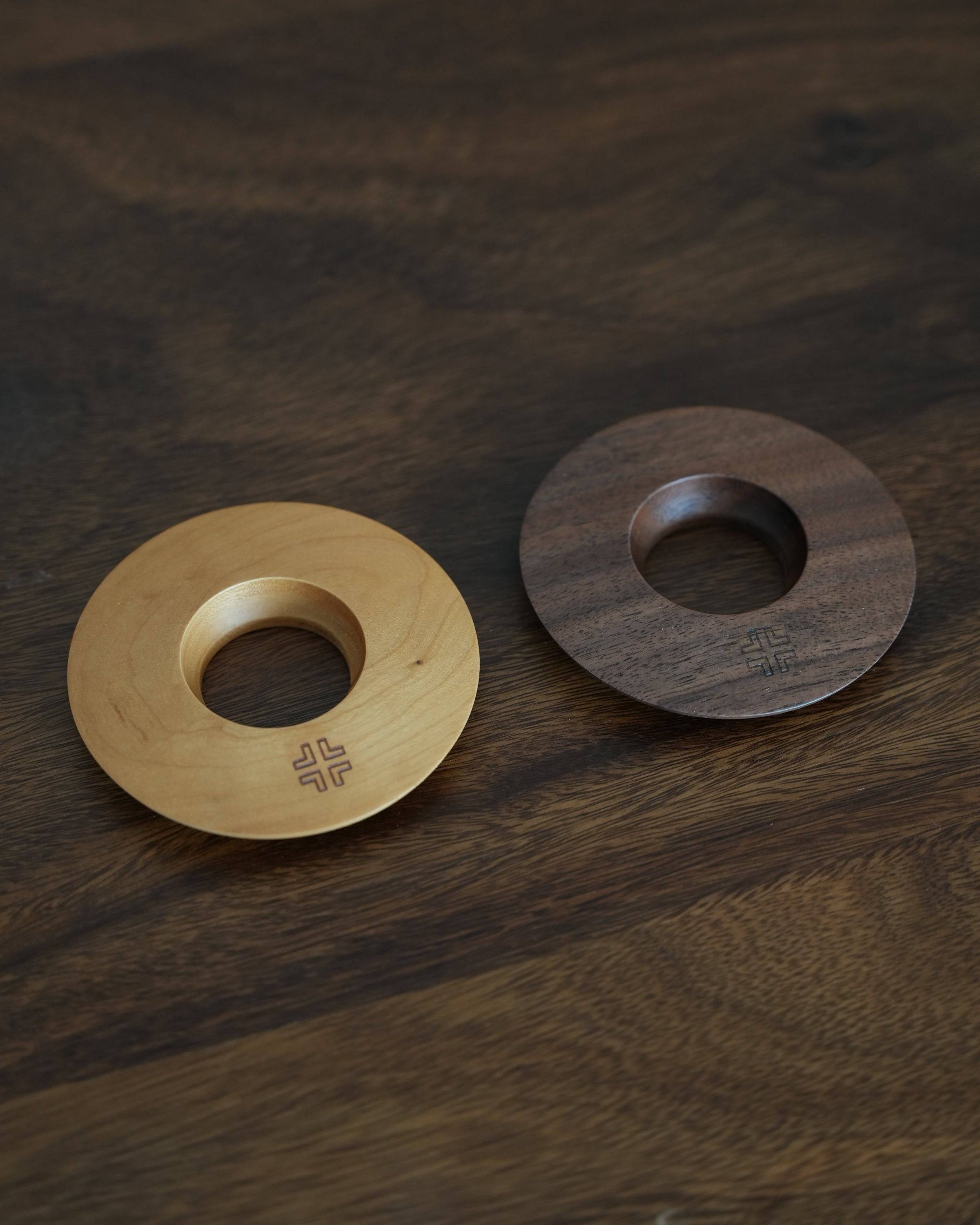 Ninety Plus Coffee Kone Ring 10.1 wooden bases in cherry and walnut colors on dark wooden surface, showcasing elegant design and craftsmanship for coffee brewing enthusiasts