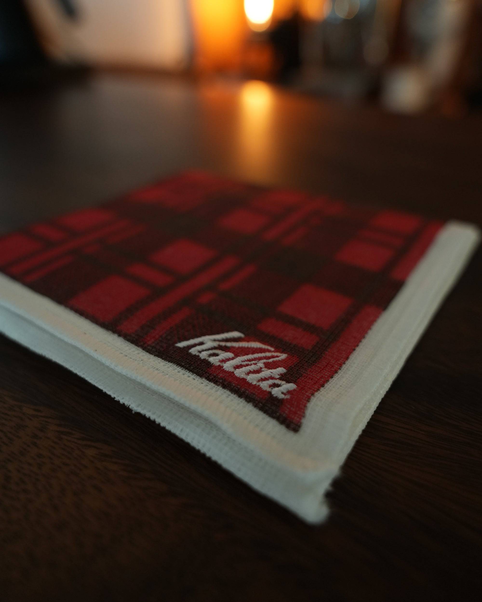 Kalita classic red plaid cloth for pour-over coffee brewing, folded on wooden surface with warm ambient lighting, showcasing high-quality cotton material and stylish design