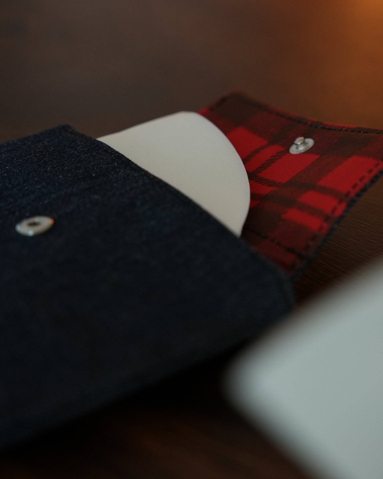 Close-up of stylish coffee filter storage bags in navy blue and red plaid patterns, showcasing button closures and quality fabric textures for Kalita or V60 filter papers