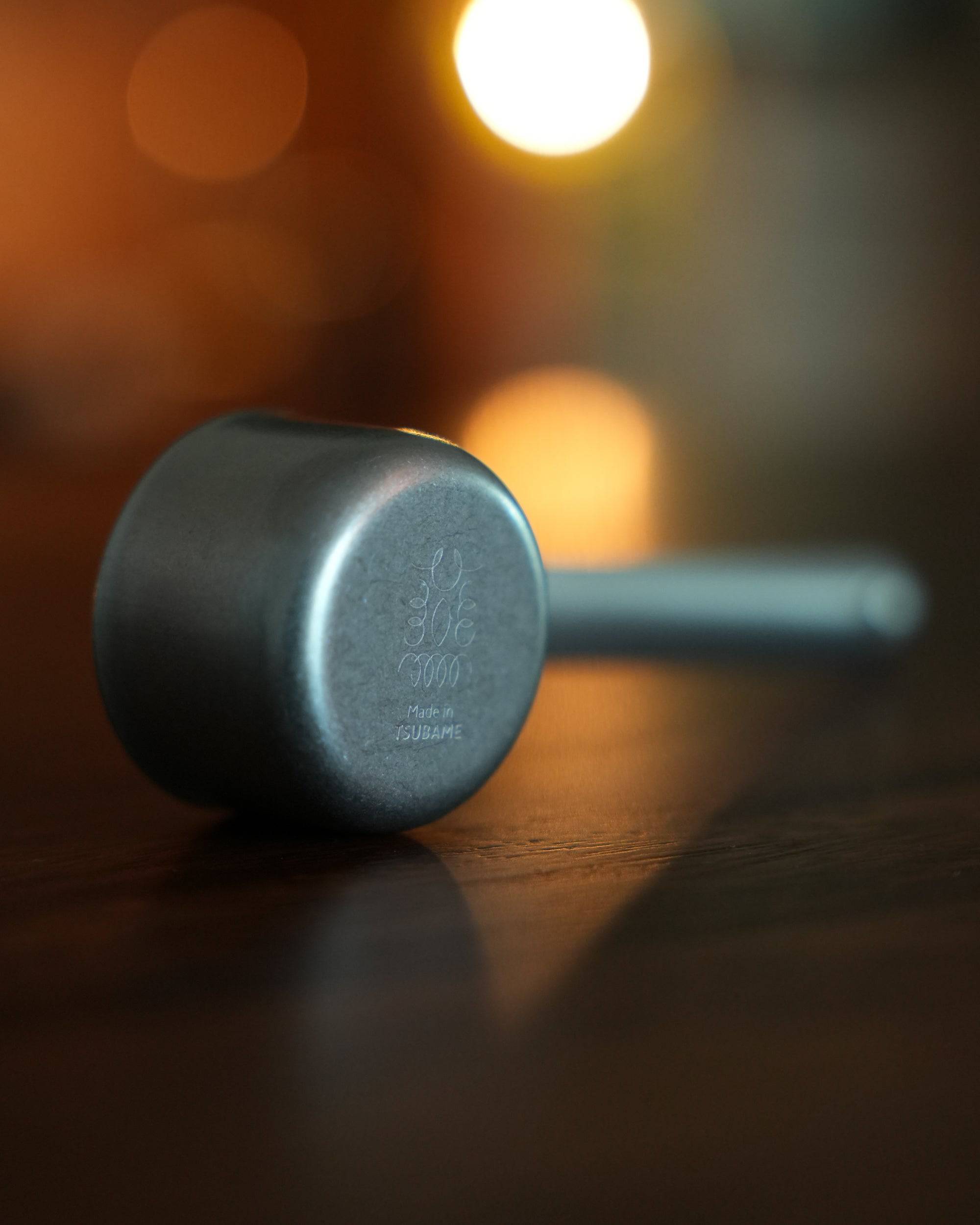 Kalita & Tsubame stainless steel coffee scoop, 10g capacity, L size, with matte finish and engraved logo, displayed on wooden surface with warm lighting, showcasing precision and elegance in coffee measurement