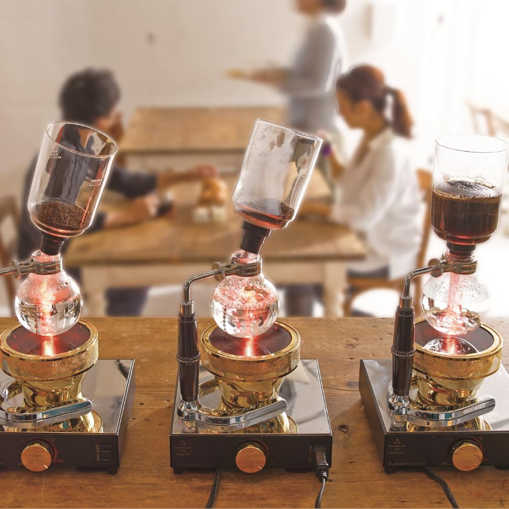 HARIO Technica siphon series brewing with gas burners on a table