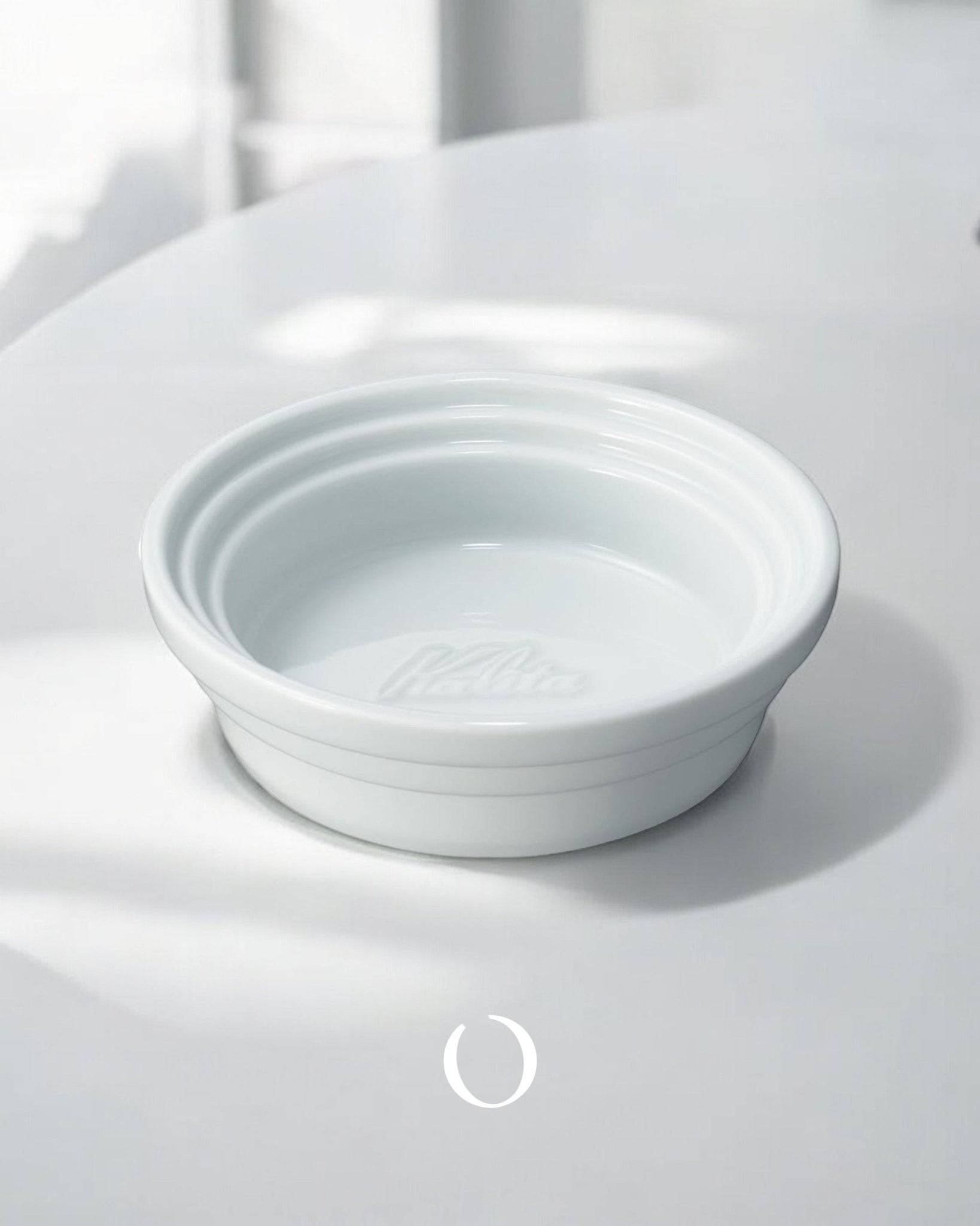 Kalita & Hasami ceramic coffee dripper tray, white porcelain, circular design with raised edges, showcasing Japanese craftsmanship for pour-over coffee brewing