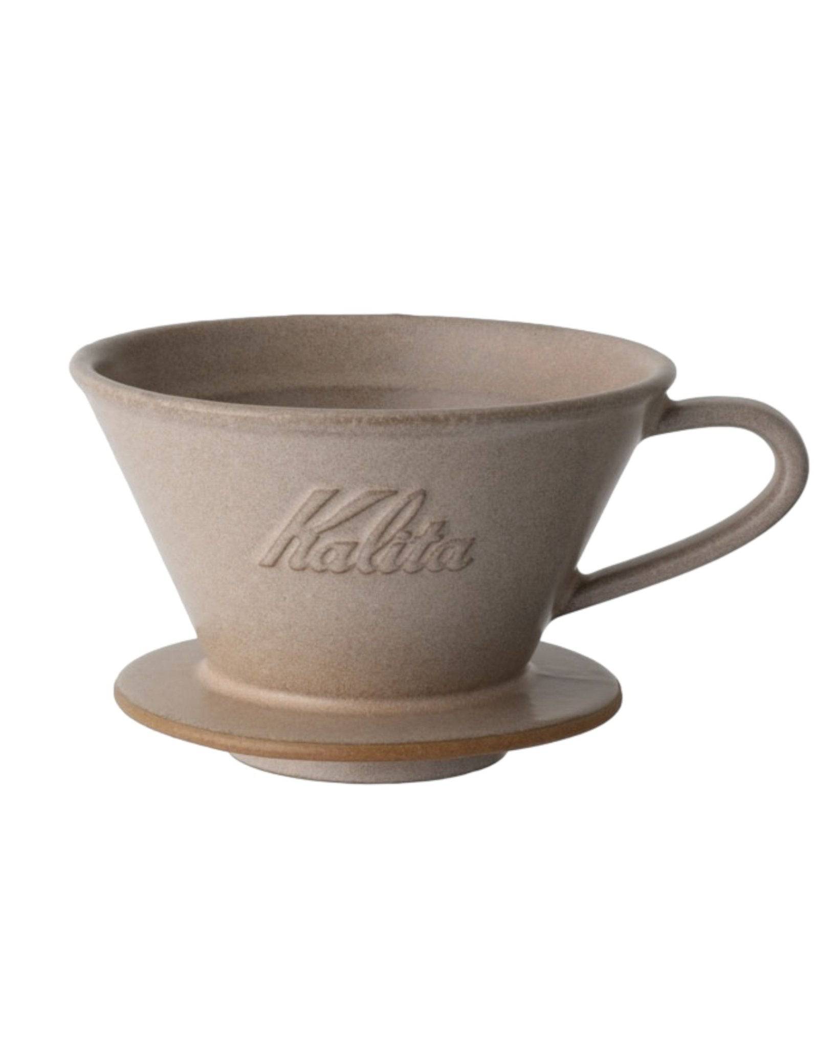 Kalita MI185 ceramic coffee dripper in beige color, featuring conical shape with flat bottom, embossed logo, and a handle for easy pouring, ideal for pour-over brewing method