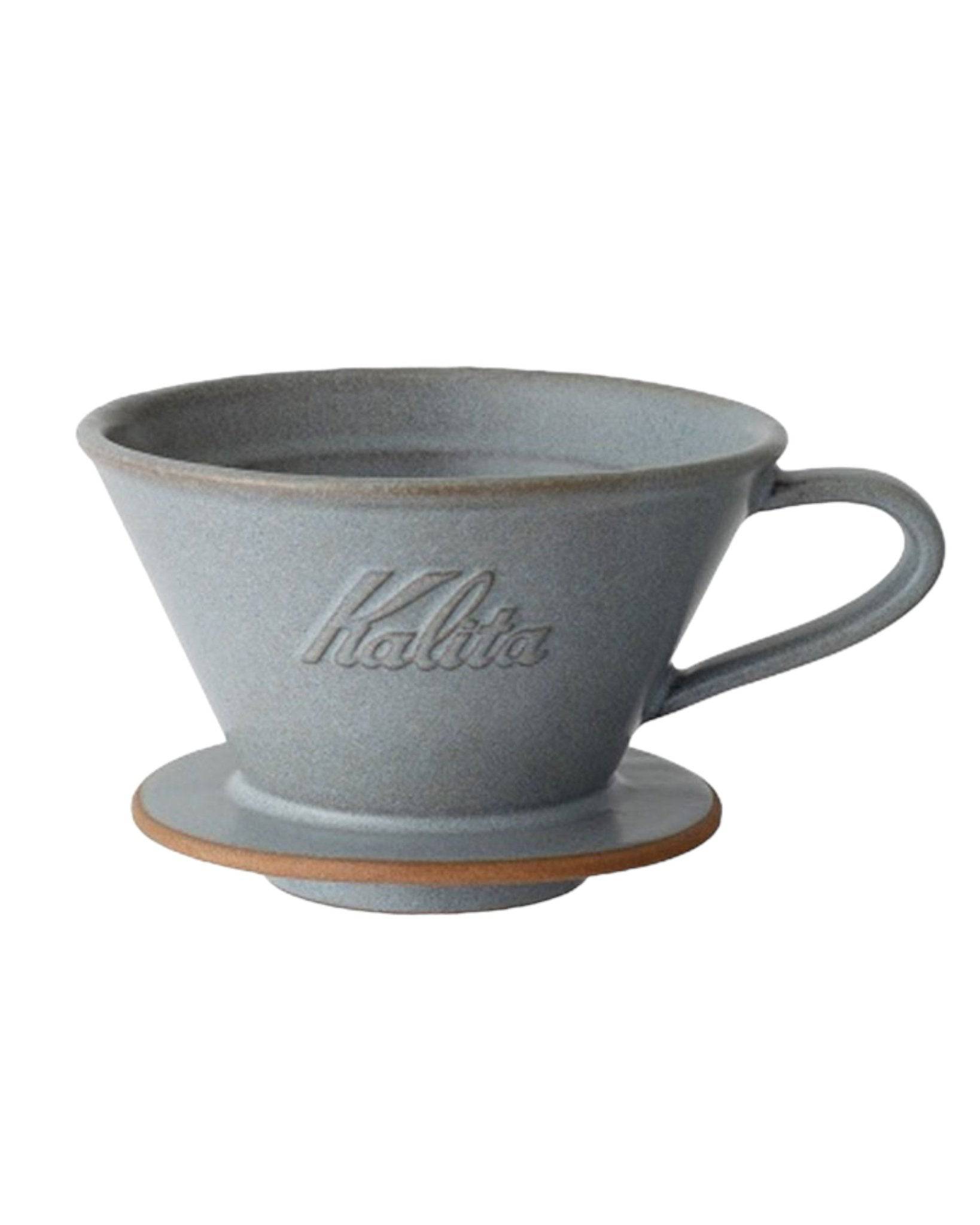 Kalita MI185 ceramic pour-over coffee dripper in gray, featuring conical shape, handle, and embossed logo, with orange base ring for precise coffee extraction