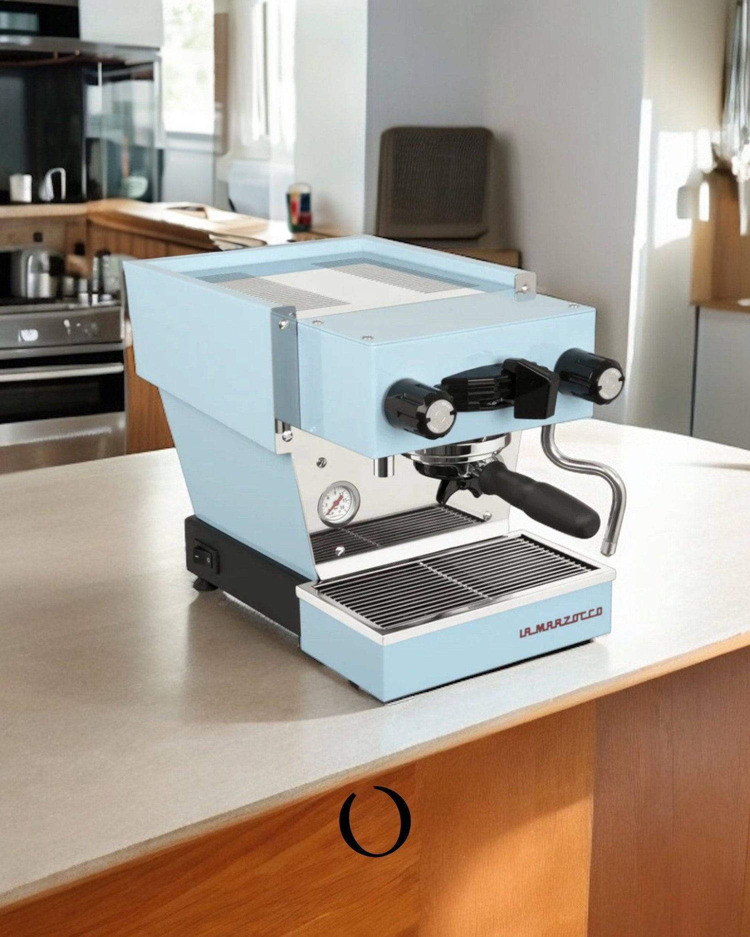 Light blue La Marzocco Linea Micra espresso machine on kitchen counter, featuring compact design with portafilter, steam wand, and pressure gauge, showcasing professional-grade coffee making capabilities for home use.