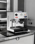 Lelit Anita pl042temd espresso machine with built-in grinder, PID temperature control, pressure gauge, and steam wand on stainless steel countertop in monochrome kitchen setting