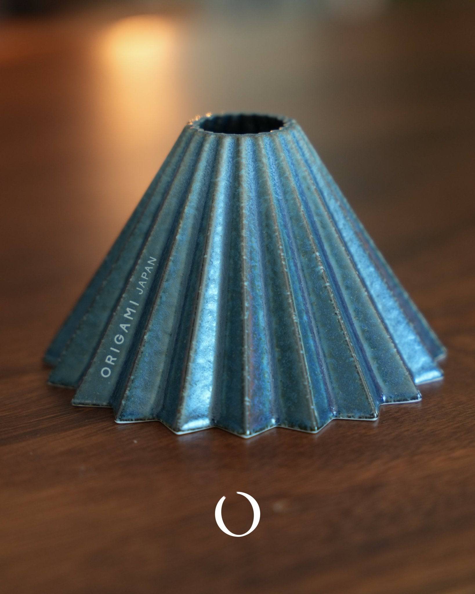 Limited edition ORIGAMI Dripper S sukumo coffee filter, featuring a unique blue-dyed ceramic design with 20 ribbed folds, showcasing traditional Japanese craftsmanship and modern coffee brewing functionality.