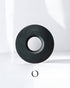Handcrafted indigo-dyed wooden dripper holder by ORIGAMI x Watanabe, featuring a circular design with a central hole, showcasing unique wood grain and deep blue hues against a white background.