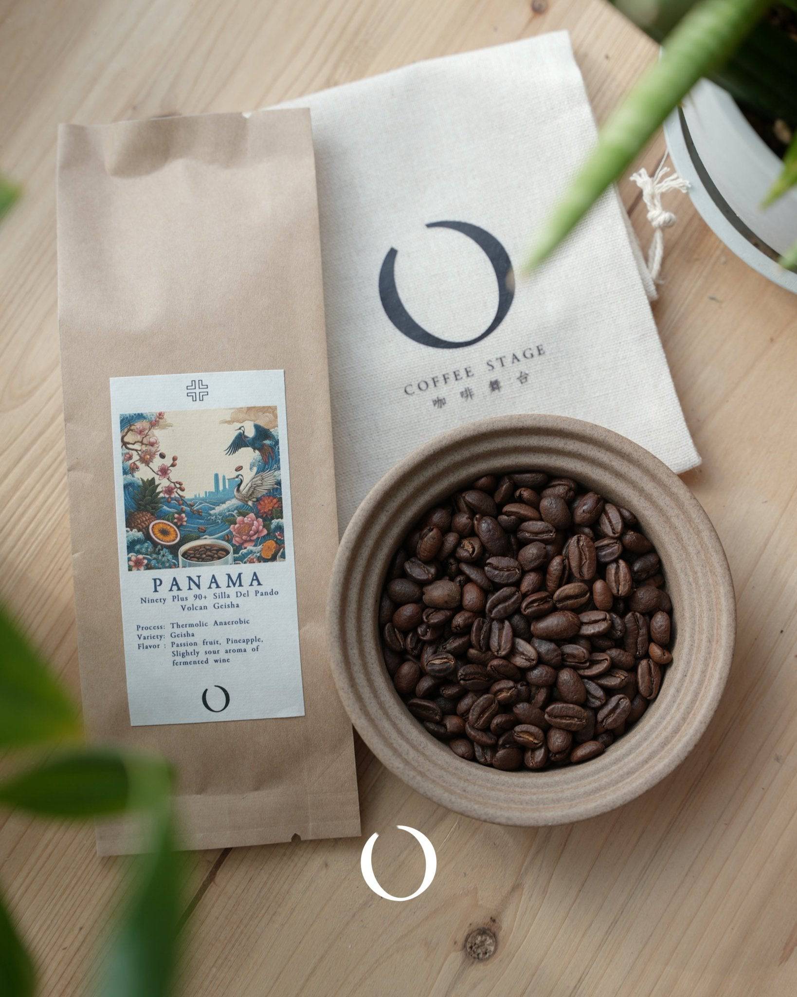 Coffee beans from Panama in ceramic bowl, alongside branded coffee bag and packaging on wooden surface, with partial view of plant leaf