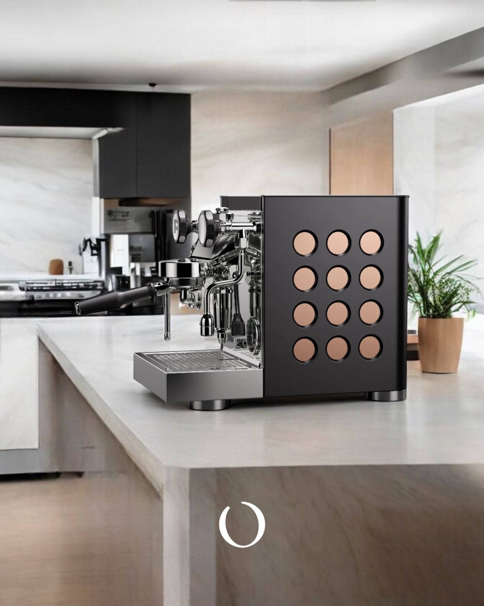 Sleek black Rocket Appartamento TCA espresso machine with distinctive circular side panel design on modern kitchen countertop, showcasing professional-grade features for home baristas.