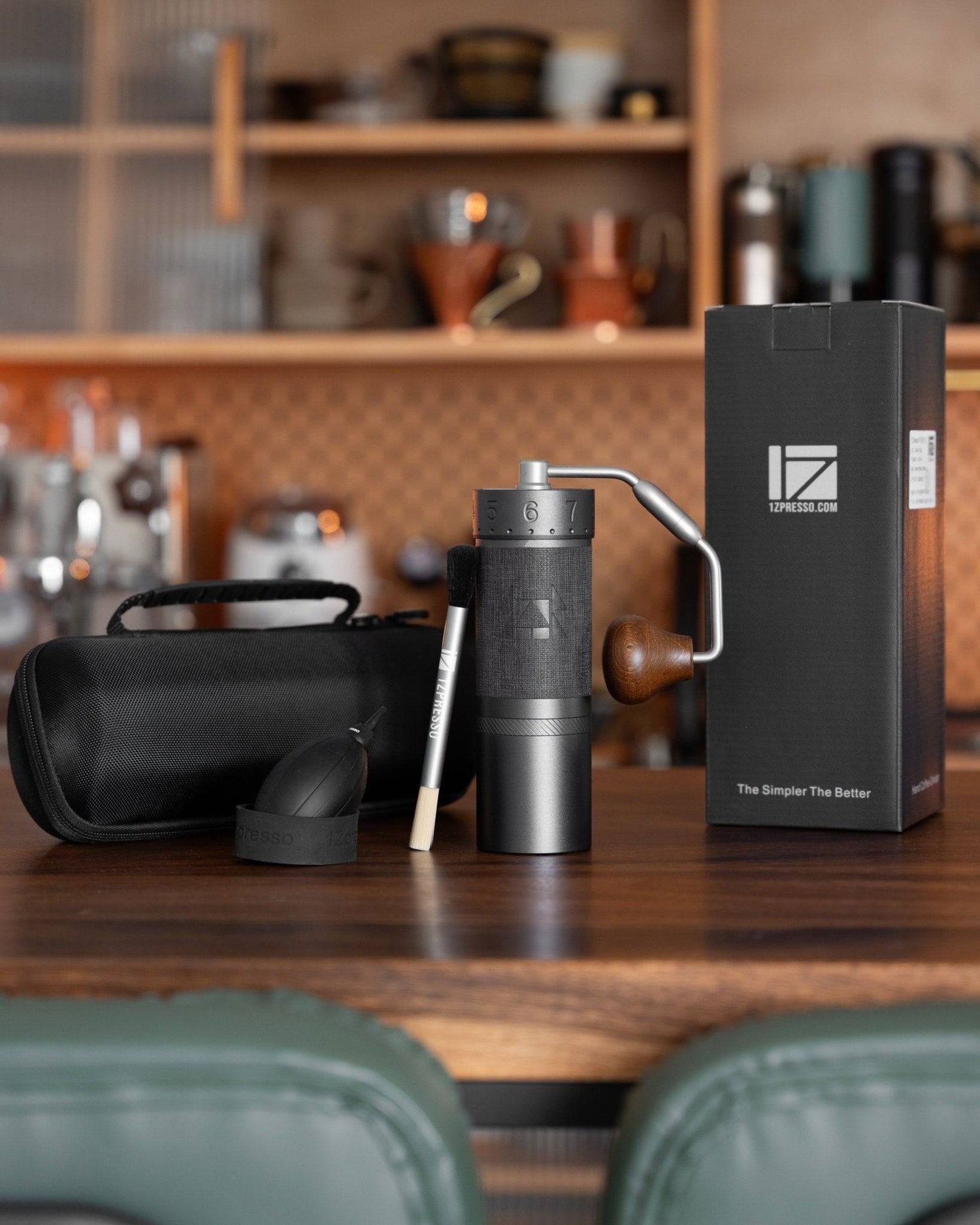 1Zpresso J MAXS manual coffee grinder with accessories on wooden countertop, showcasing sleek design and precision grinding capabilities for espresso and other brewing methods