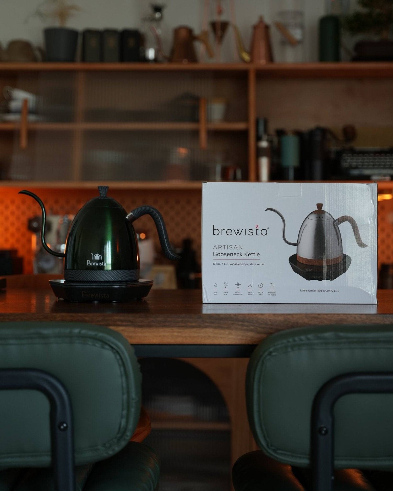 Brewista Artisan gooseneck kettle displayed on wooden counter with product box, showcasing precise temperature control for optimal coffee brewing in stylish kitchen setting