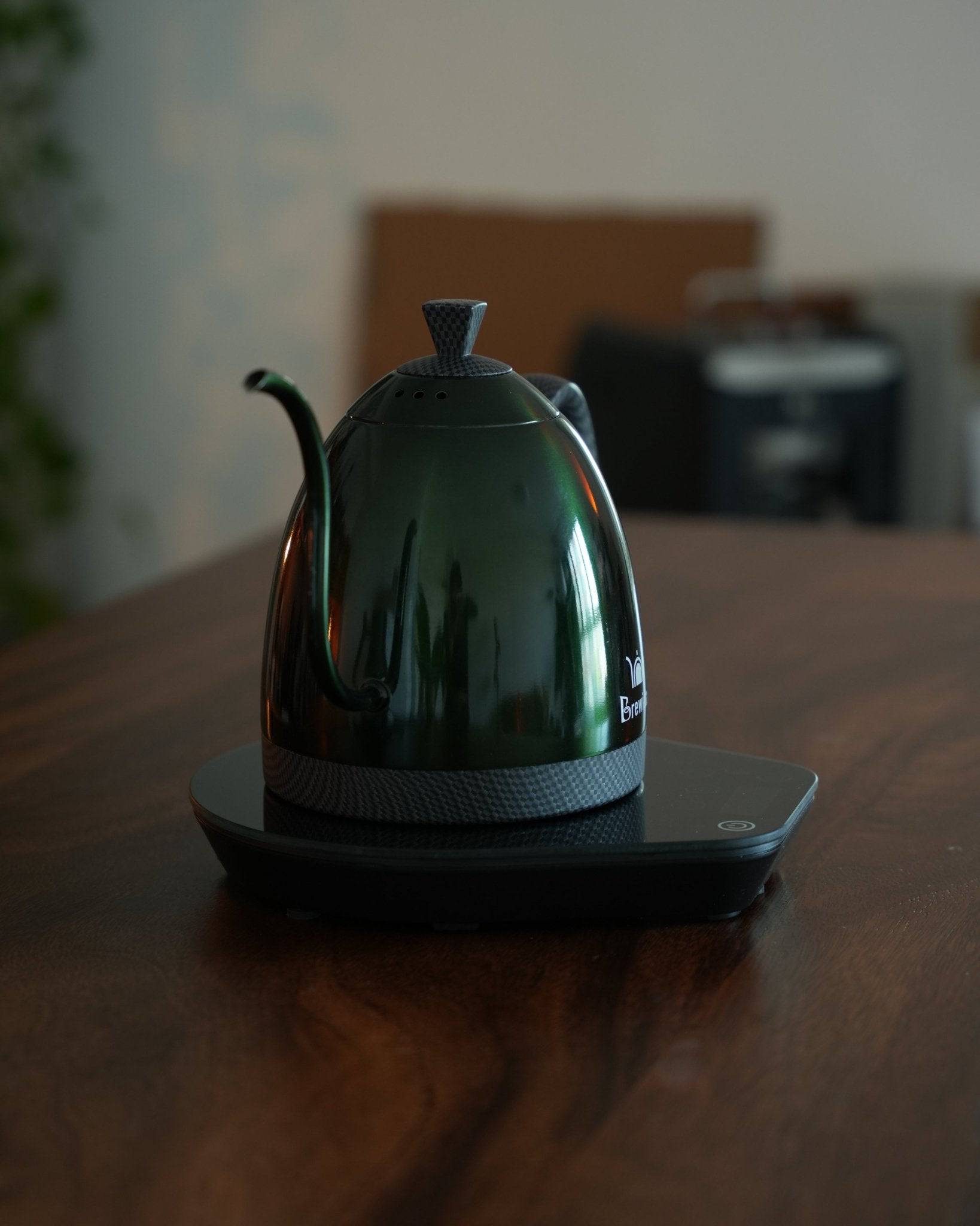 Sleek green Brewista Artisan temperature-controlled kettle on charging base, showcasing its elegant design and professional-grade features for precise coffee brewing