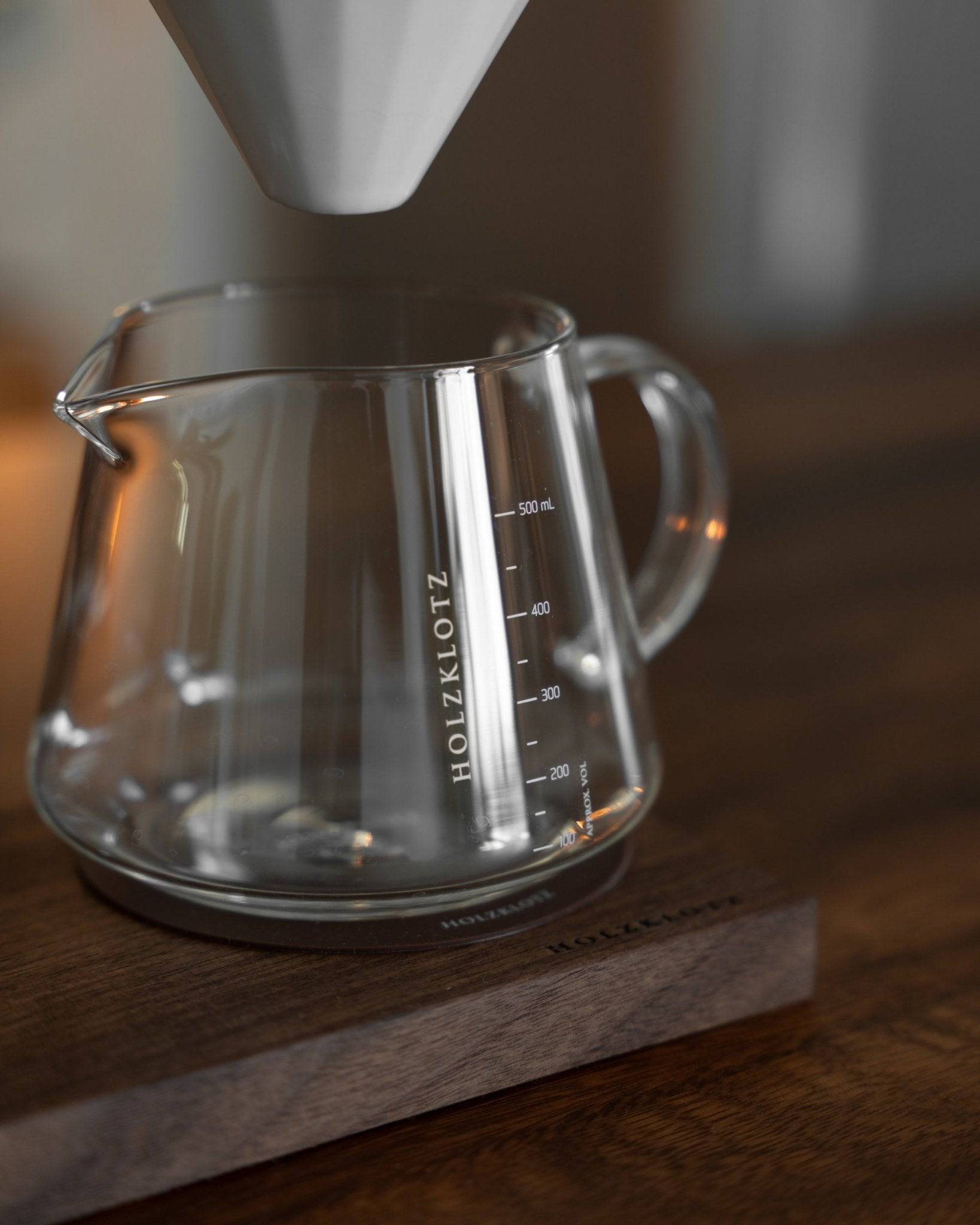 Holzklotz pour-over coffee set with glass carafe and white ceramic dripper, showcasing elegant design and premium quality for home brewing enthusiasts