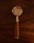 IKAPE 58mm bottomless portafilter with wooden handle and stainless steel filter basket, showcasing professional espresso extraction capabilities on dark wooden background