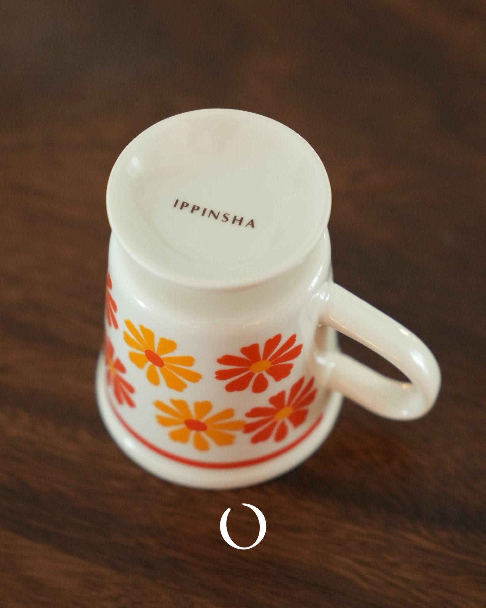 Ippinsha vintage coffee cup with orange and yellow floral pattern, ceramic mug on wooden surface, retro Showa era design, 250ml capacity, Japanese aesthetic