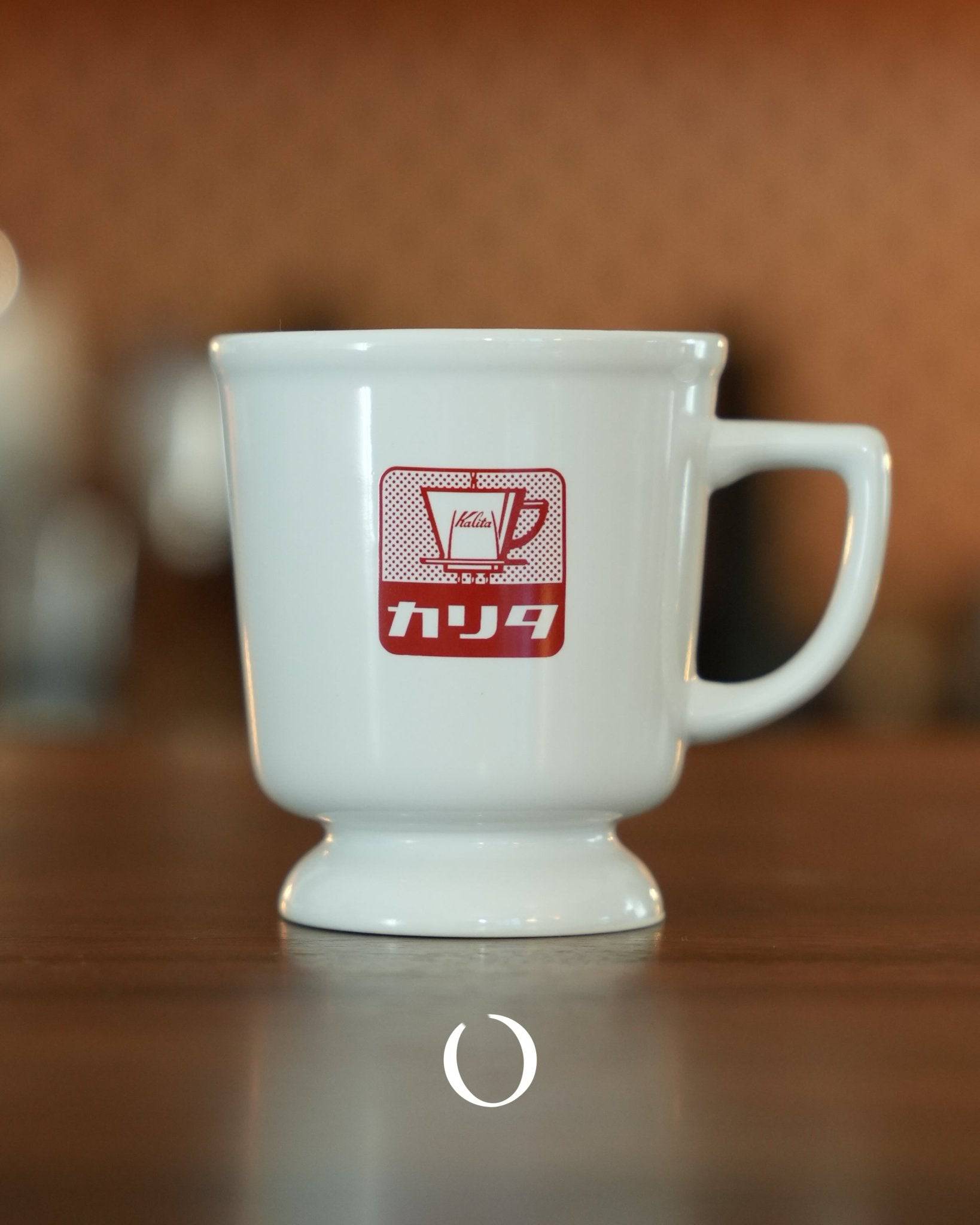 Vintage Kalita coffee mug in white ceramic with red retro logo, showcasing Showa era design on wooden surface, perfect for nostalgic coffee experience