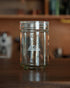 Kalita glass coffee storage jar with airtight lid, 300g capacity, transparent design with brand logo, on wooden surface in kitchen setting