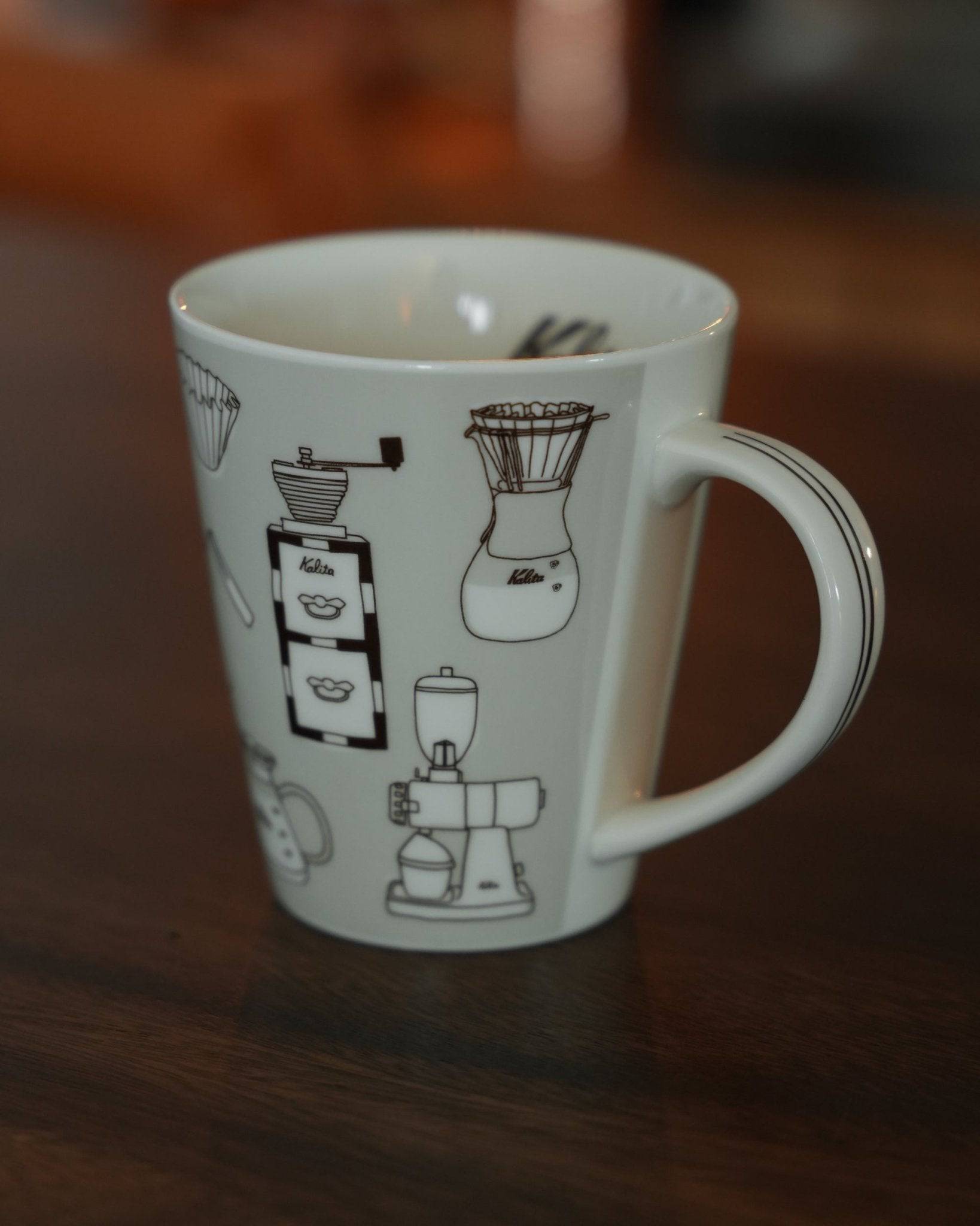 Kalita ceramic mug with coffee equipment illustrations, warm gray color, 300ml capacity, on wooden surface, perfect for coffee lovers and collectors
