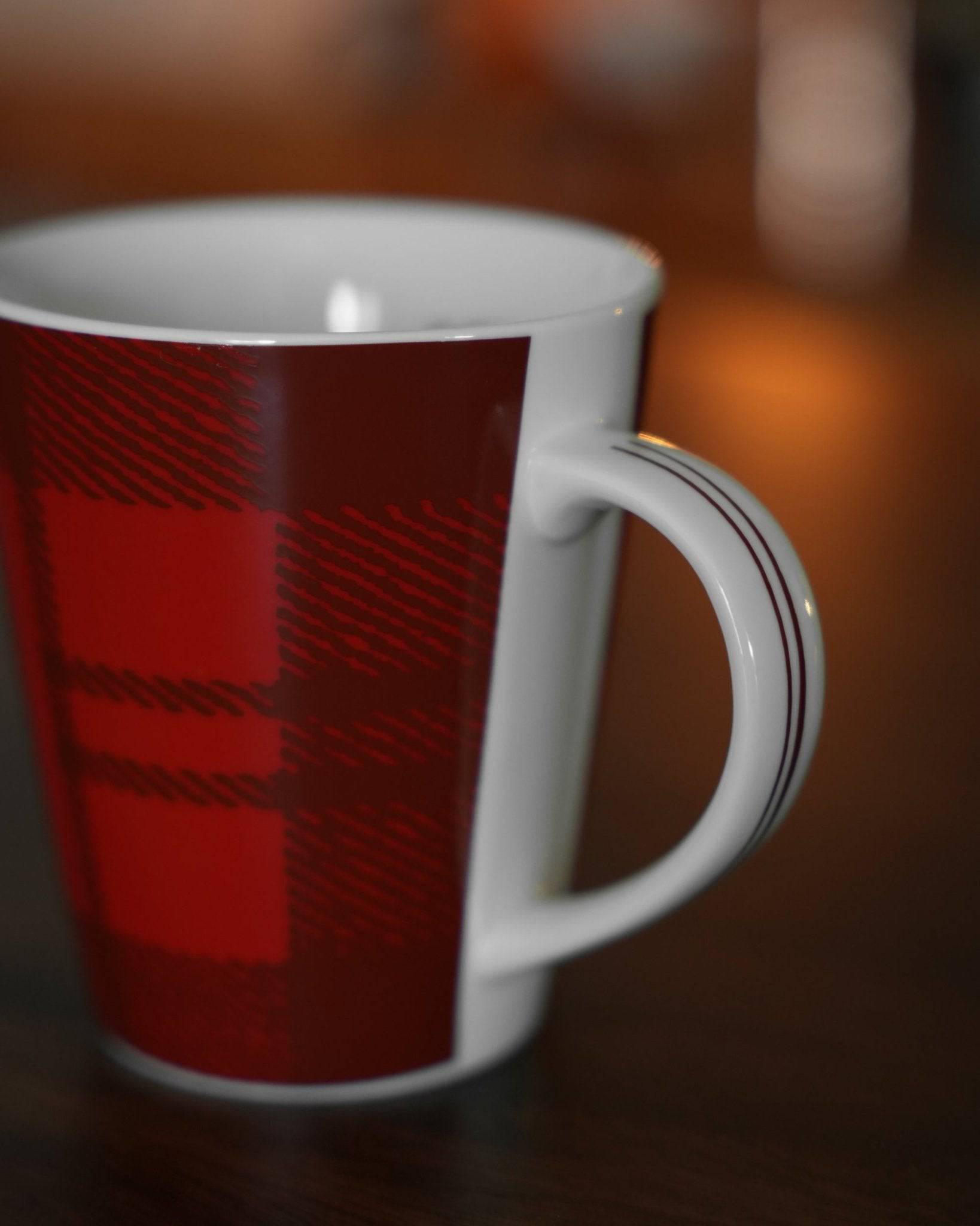 Kalita ceramic mug with red checkered pattern, 300ml capacity, white interior, close-up view on wooden surface with warm background lighting