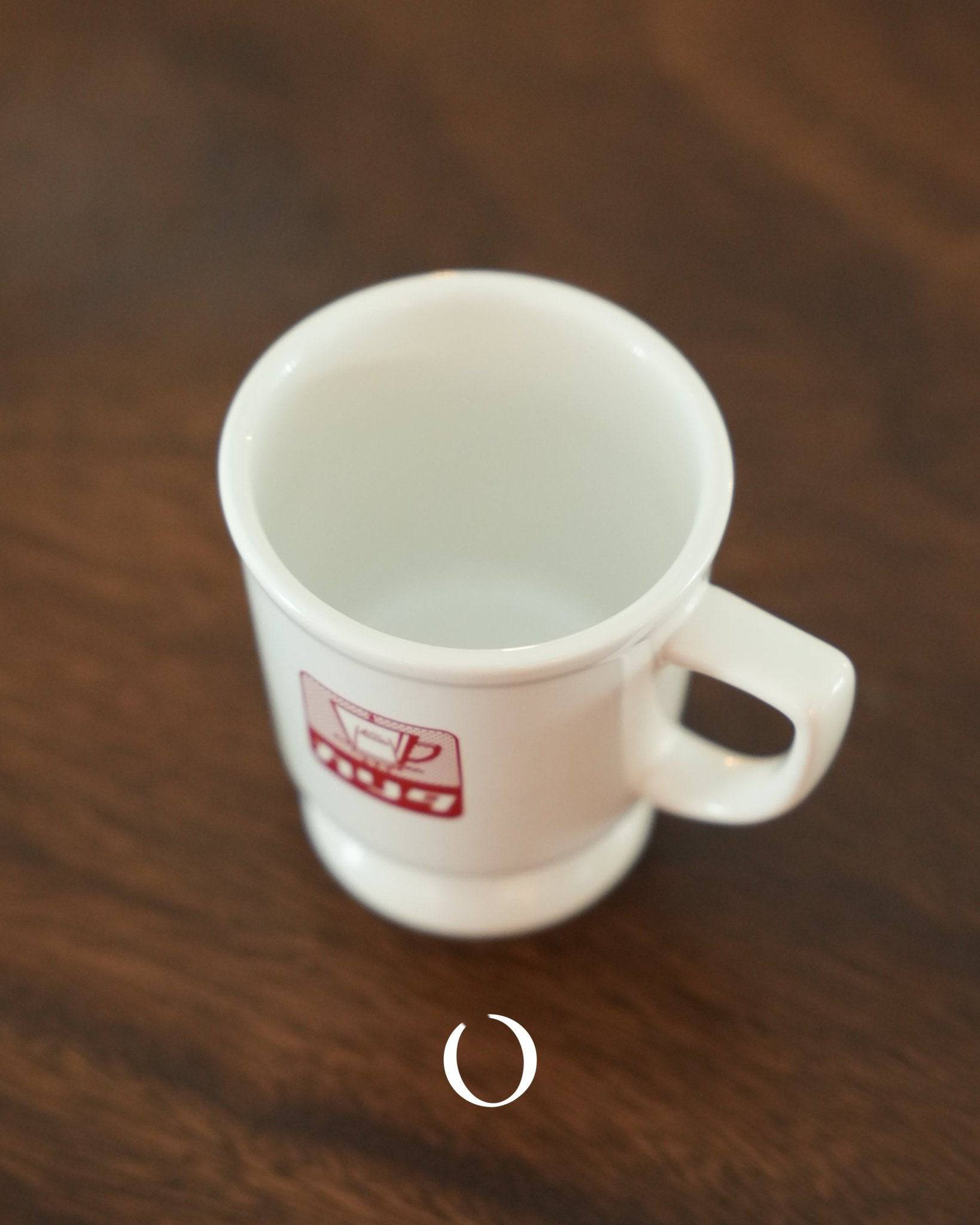 Vintage Kalita ceramic coffee mug with red logo on white background, showcasing Showa era design, wide mouth, and raised bottom for heat insulation, placed on wooden surface