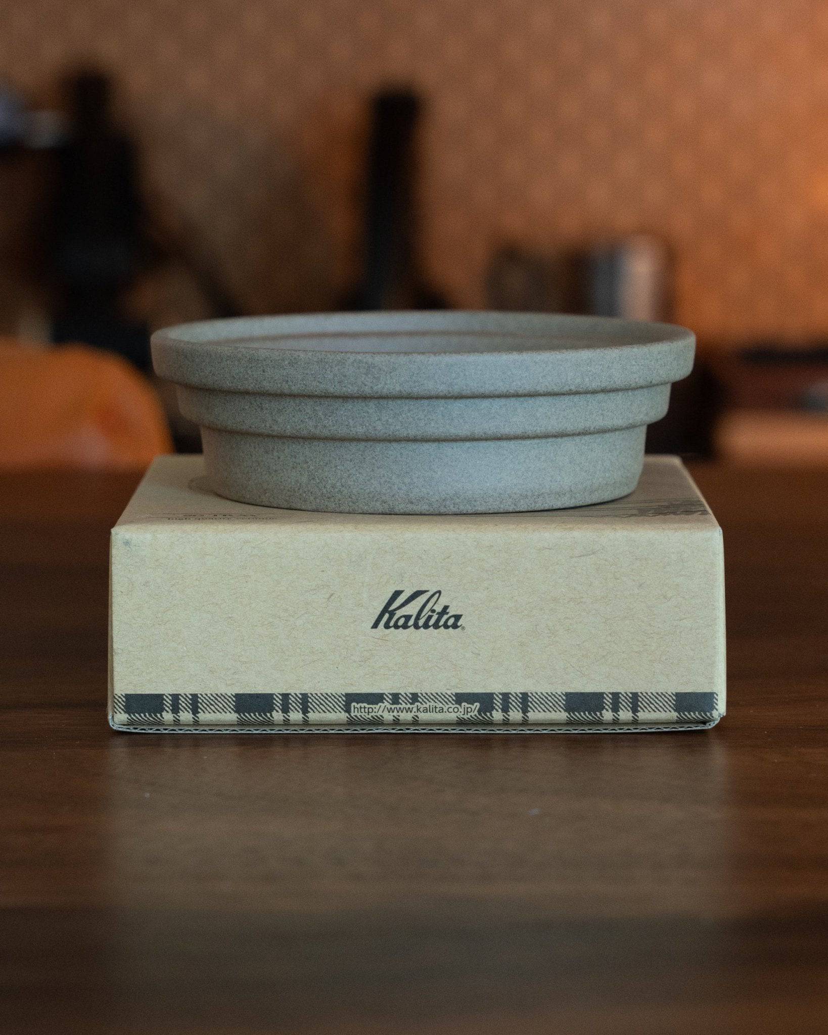 Kalita & HASAMI sandstone coffee dripper tray on branded box, showcasing Japanese Hasami-yaki craftsmanship with a minimalist design, suitable for various Kalita wave drippers and enhancing coffee brewing experience.