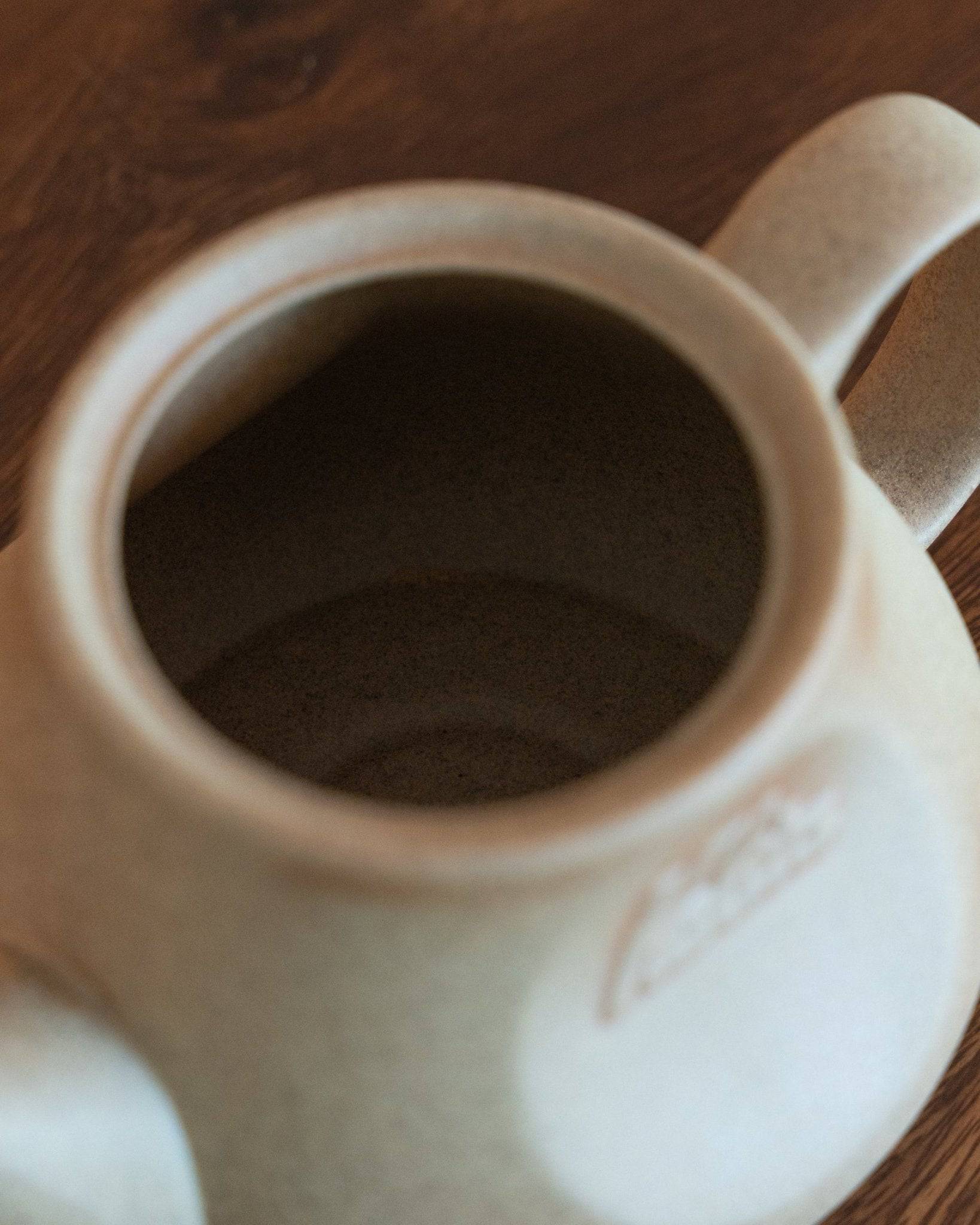 Close-up view of a Kalita & HASAMI sandstone coffee pot, showcasing its smooth texture and elegant design. The pot&