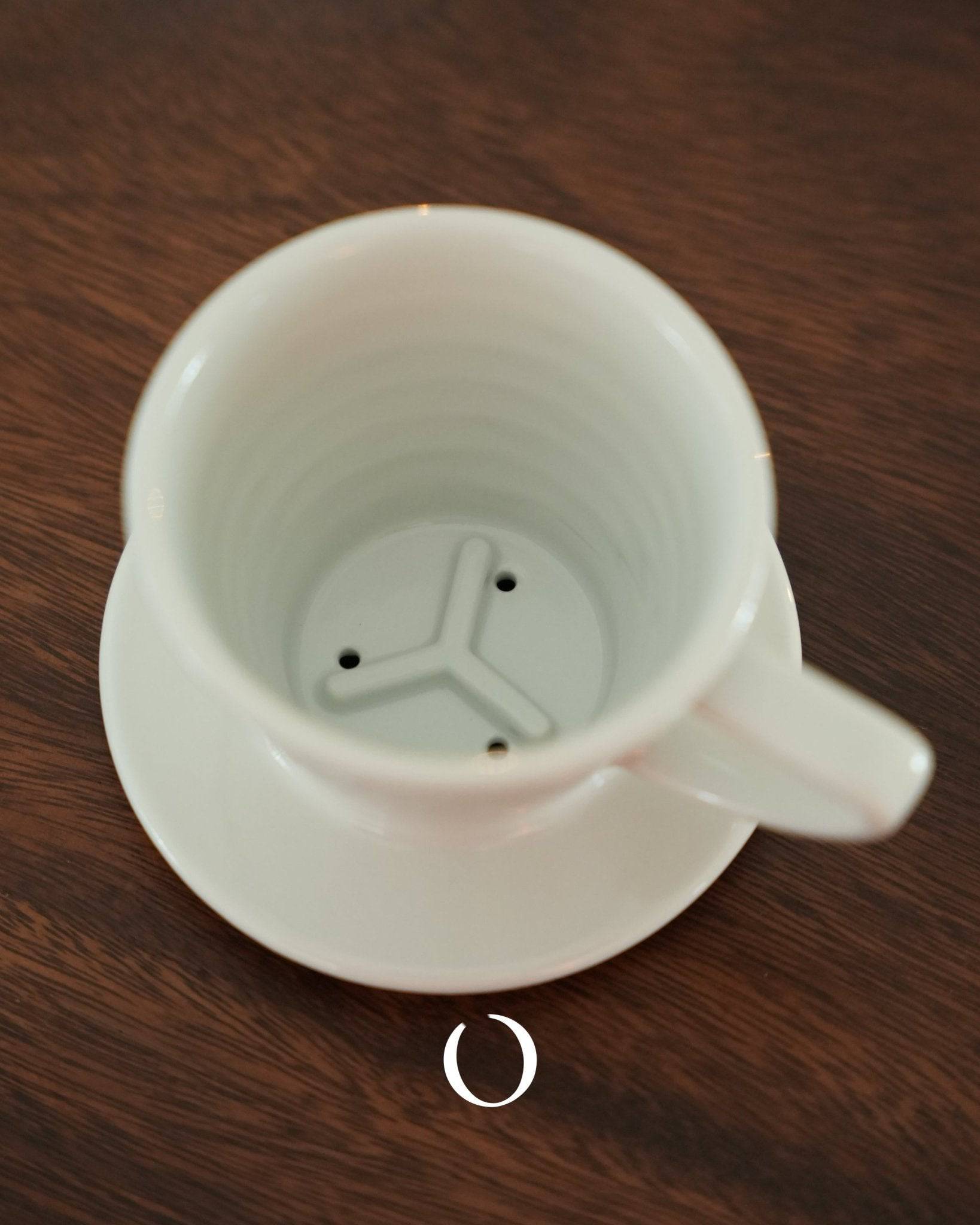 KALITA & HASAMI ceramic coffee dripper with three-hole design, showcasing traditional Hasami-yaki craftsmanship and modern functionality for optimal brewing, placed on a wooden surface