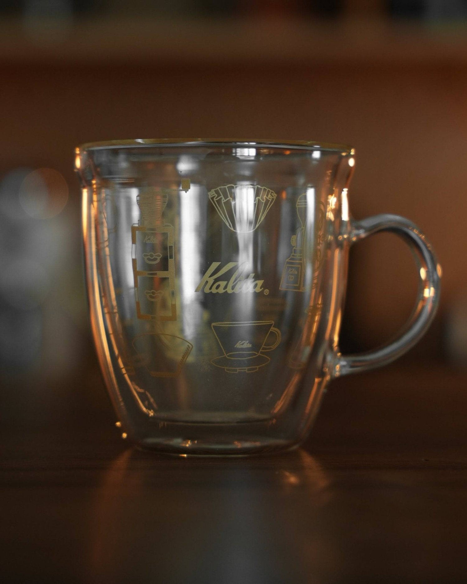 Kalita double-walled glass mug with coffee grinder and filter illustration, transparent design showcasing brand logo and coffee equipment graphics
