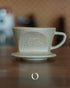 Kalita SG series sandstone clay pour-over dripper, unglazed beige ceramic coffee filter with embossed logo, showcasing traditional Hasami-yaki craftsmanship for optimal coffee extraction and heat retention