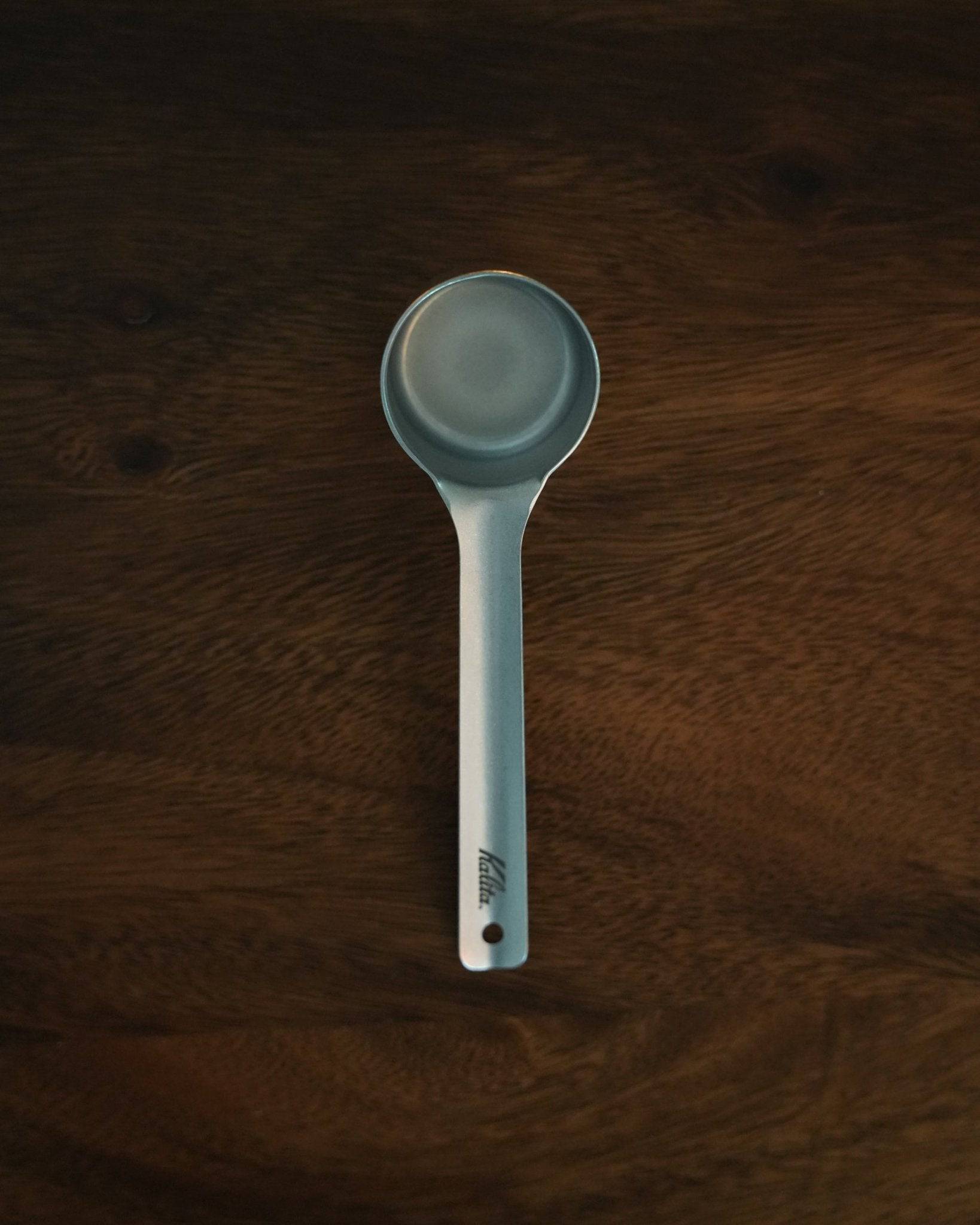 Kalita & Tsubame stainless steel coffee measuring spoon, 10g capacity, L Size, matte finish, on dark wooden background, precision coffee tool