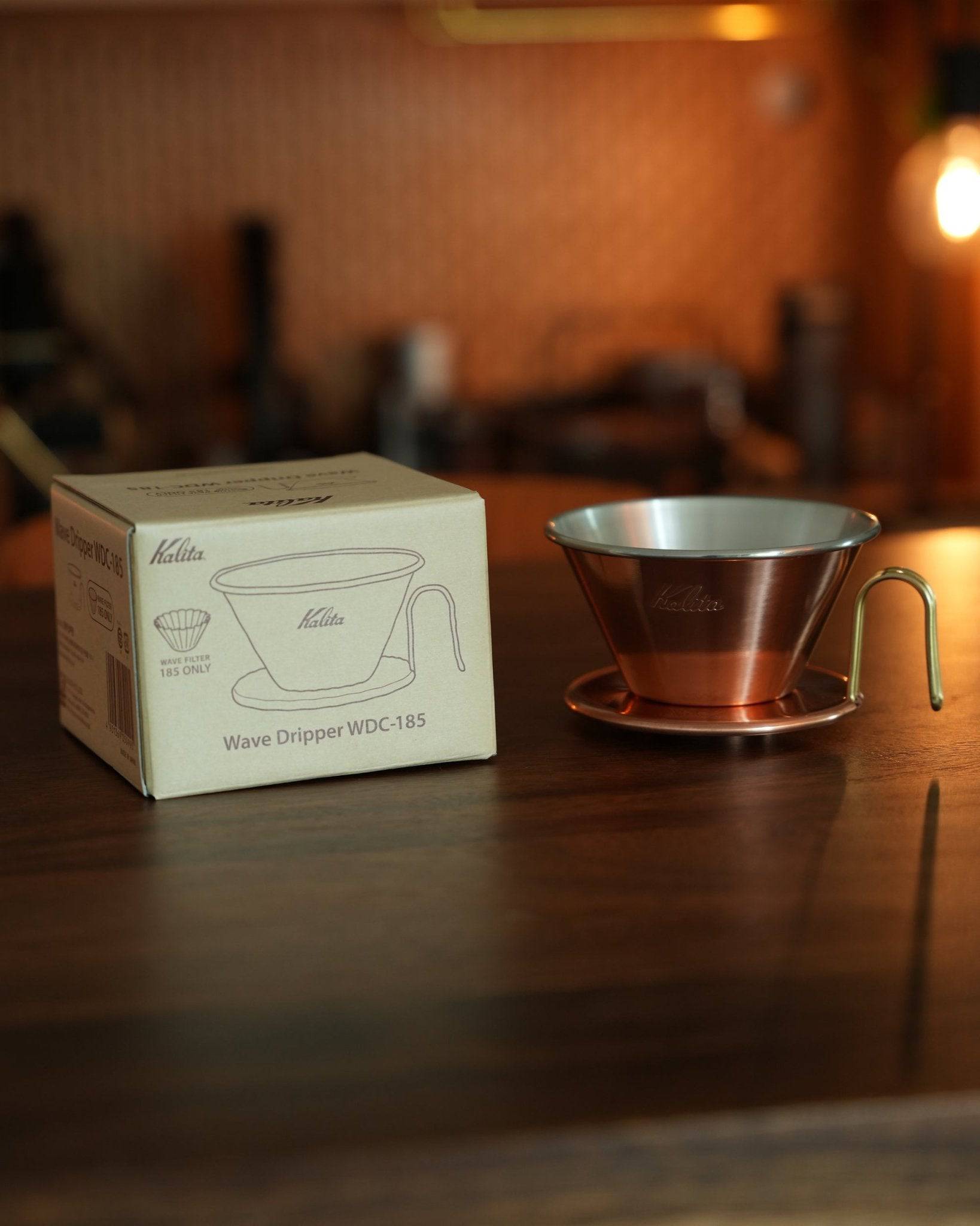 Kalita & TSUBAME WDC-185 copper pour-over dripper with box on wooden table, showcasing elegant design and premium craftsmanship for coffee brewing enthusiasts