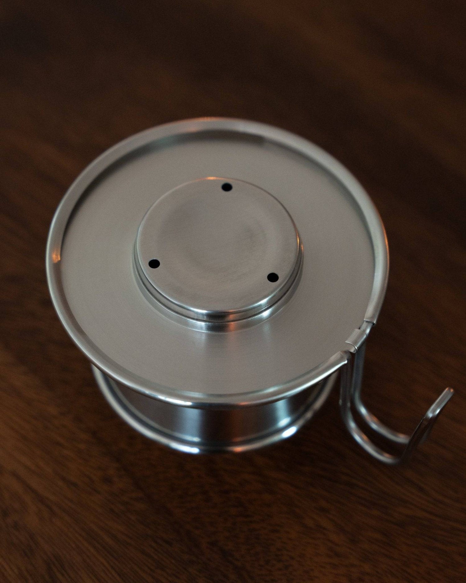 Kalita & TSUBAME WDS-155 stainless steel coffee dripper with three-hole design, handcrafted in Japan, on wooden surface. Elegant and durable pour-over coffee maker for optimal flavor extraction.