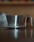 Kalita & TSUBAME WDS-155 stainless steel coffee dripper with three-hole design, handcrafted in Japan, on wooden surface. Elegant and efficient pour-over coffee maker for optimal brewing.