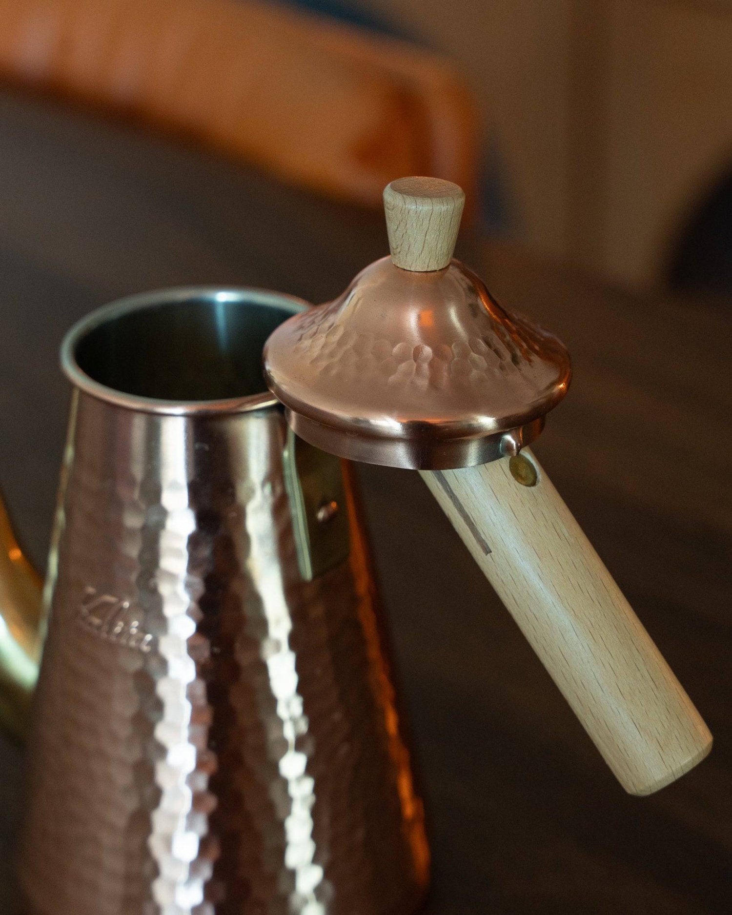 Kalita x Tsubame copper pour-over kettle with wooden handle and lid, showcasing its hammered texture and gooseneck spout for precise pouring, reflecting Japanese craftsmanship and design