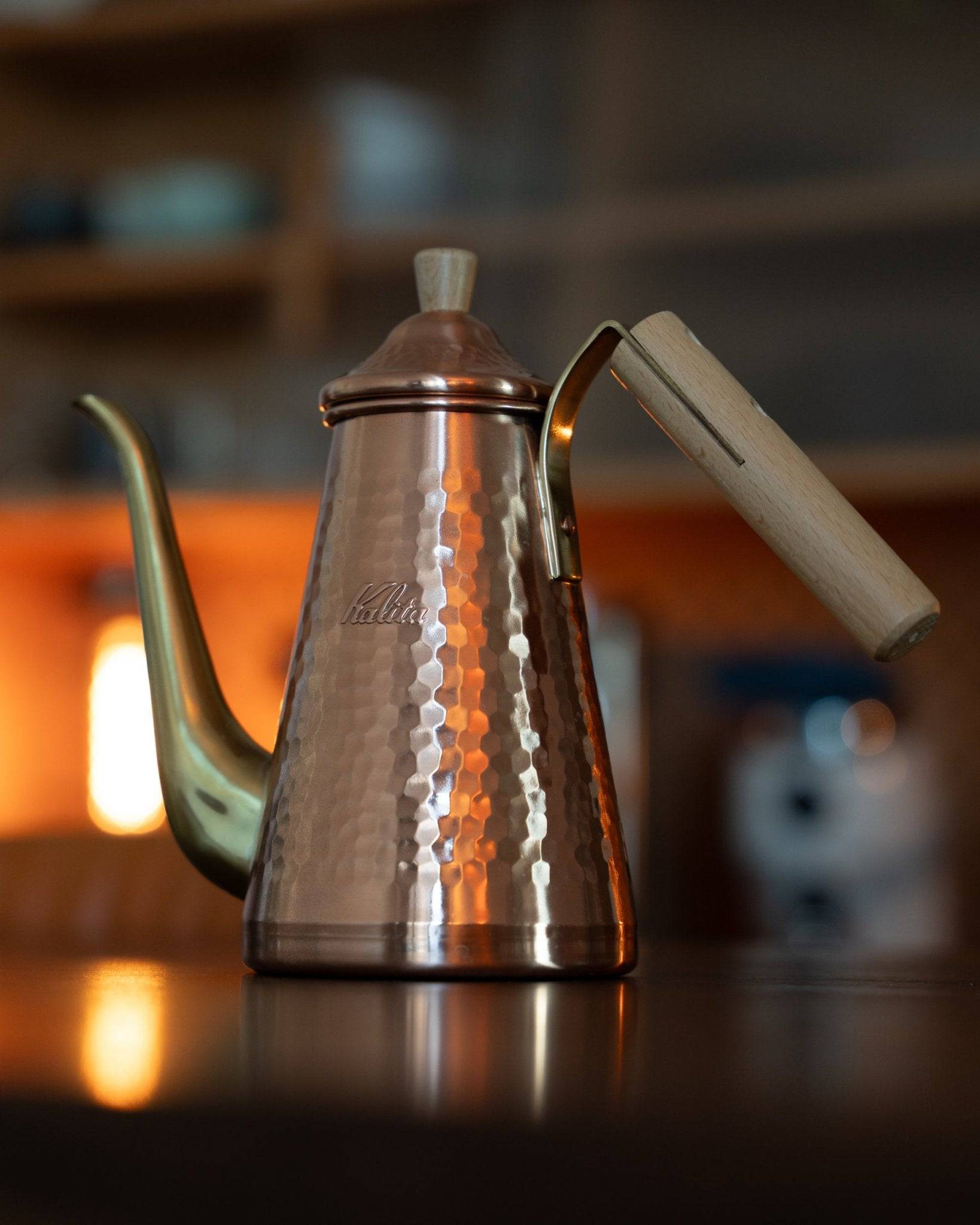 Kalita x Tsubame copper pour-over kettle with gooseneck spout and wooden handle, featuring hammered texture and elegant design, ideal for precise coffee brewing