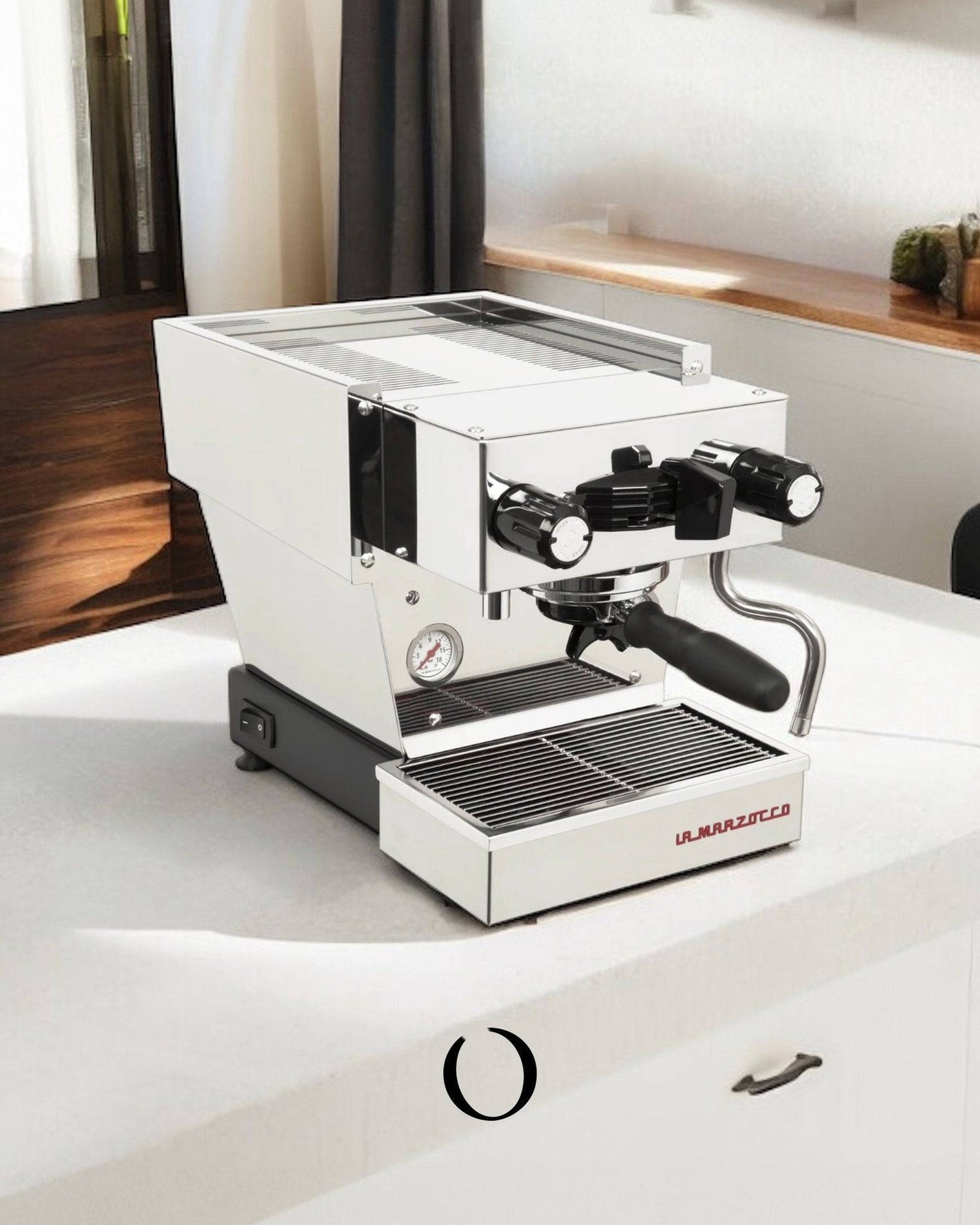 La Marzocco Linea Micra espresso machine in stainless steel on white countertop, compact design with dual boilers and convertible portafilter for home baristas