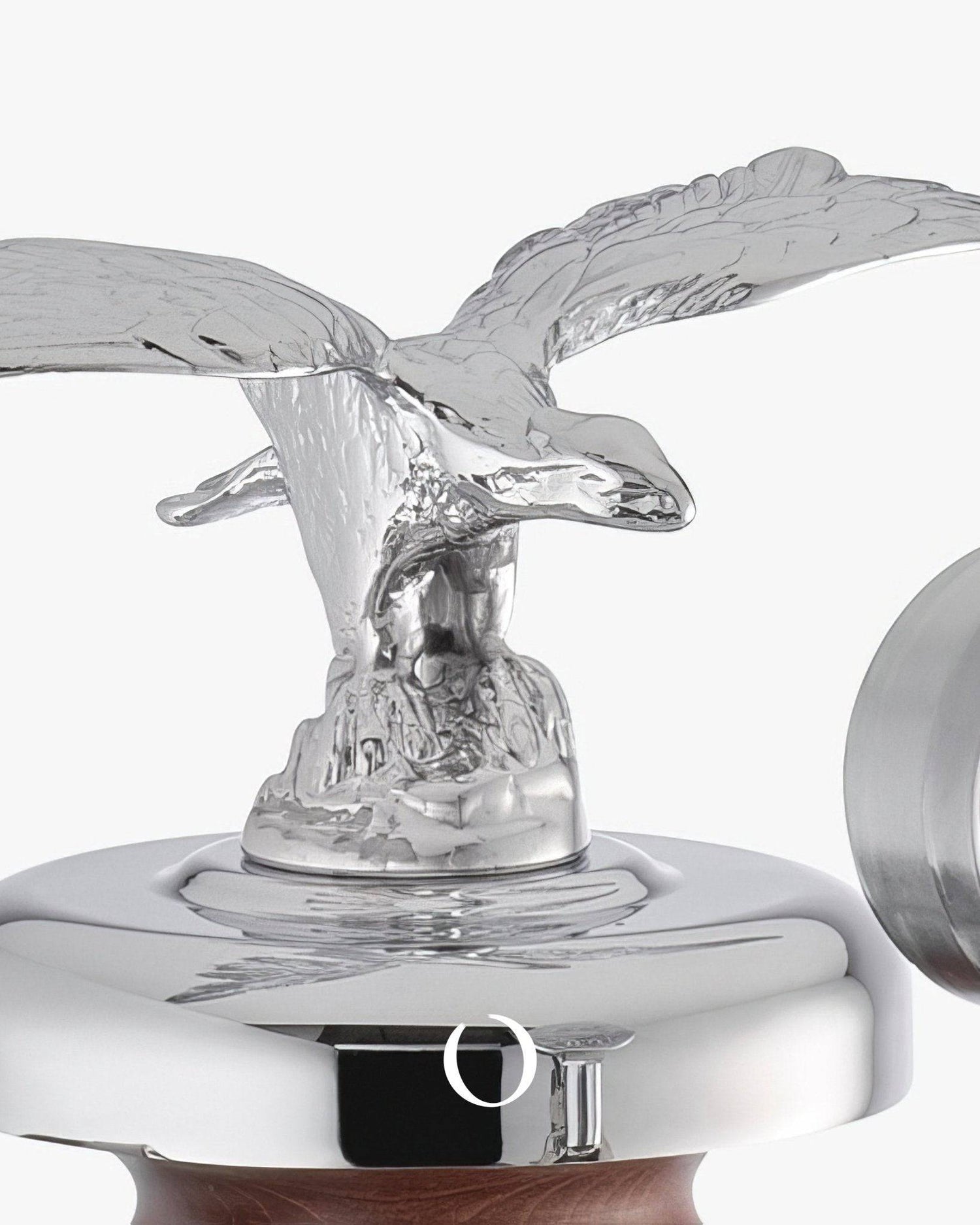 Silver eagle figurine atop La Pavoni Esperto Abile espresso machine, showcasing chrome body and wooden handle detail