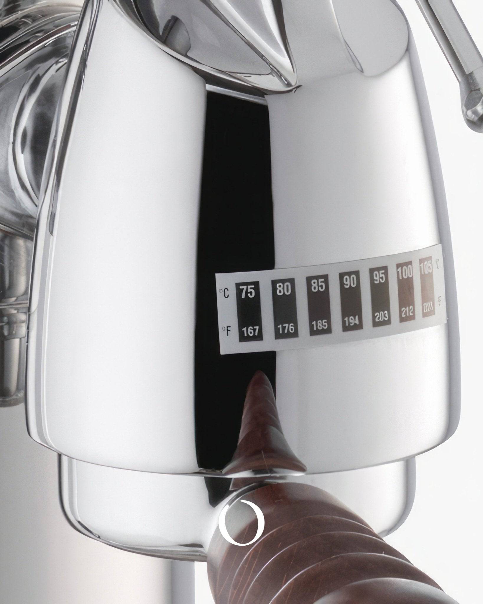 Close-up of La Pavoni Esperto Abile espresso machine, showing sleek chrome body, temperature gauge, and wooden handle, highlighting its professional-grade features and elegant design for crafting custom espresso drinks