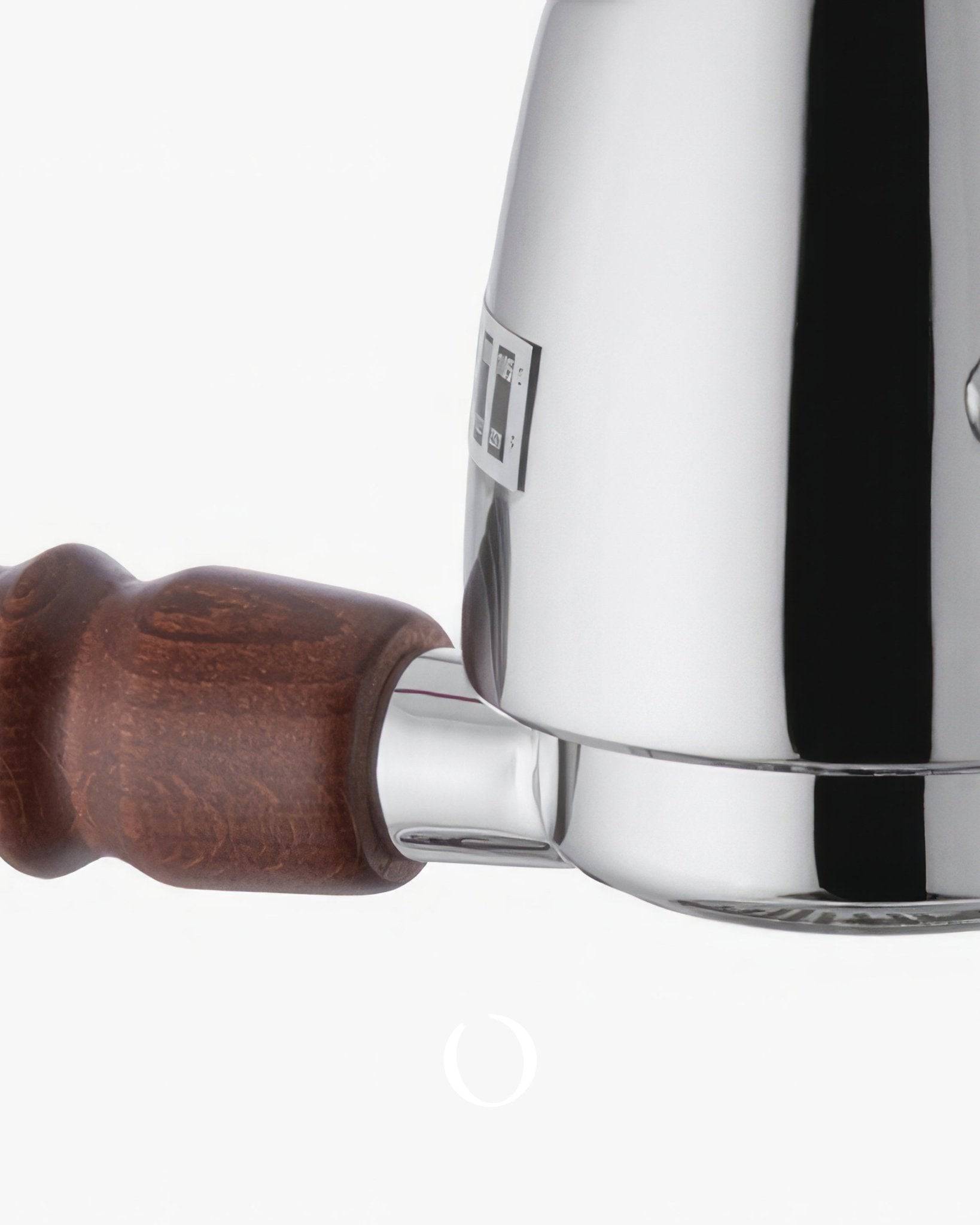 Close-up of La Pavoni Esperto Abile espresso machine, showing polished chrome body and wooden handle of portafilter, highlighting professional-grade construction and classic design elements