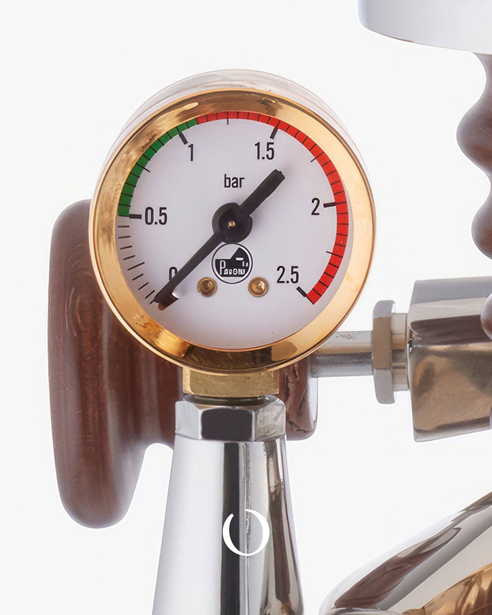 Close-up of pressure gauge on La Pavoni espresso machine, showing brass rim and wooden handle, indicating brewing pressure for professional-grade espresso extraction