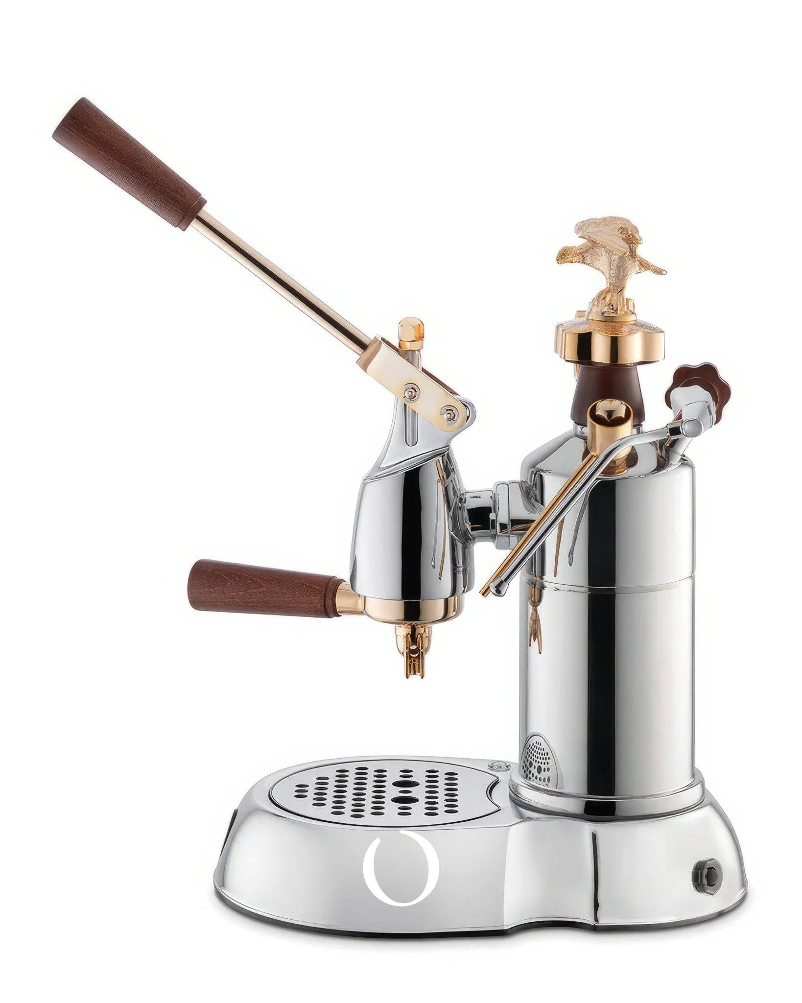 La Pavoni EXPO lever espresso machine with chrome body, gold eagle emblem, wooden handles, and drip tray. Features pressure gauge and steam wand for professional coffee brewing.