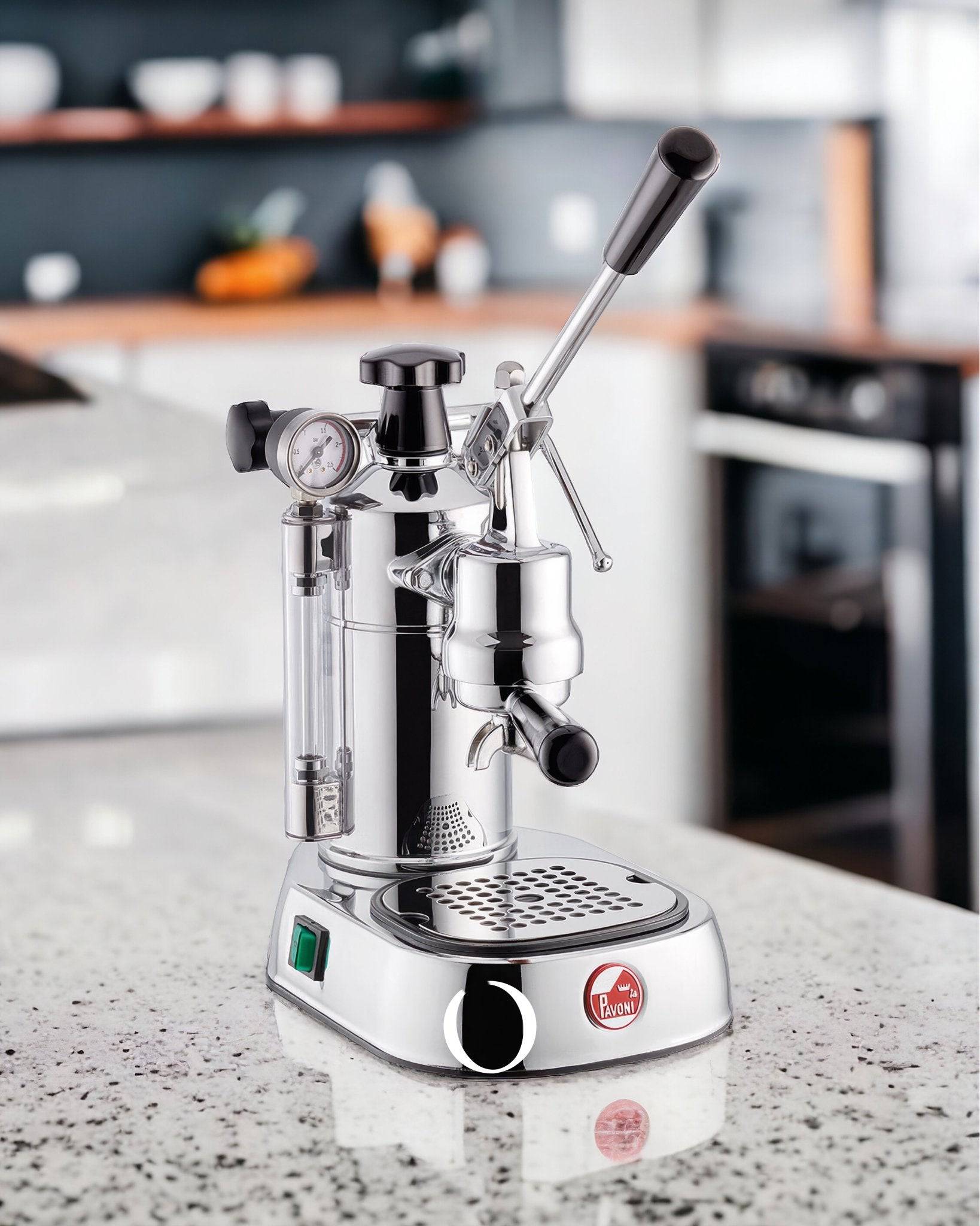 La Pavoni Professional Lusso lever espresso machine on kitchen counter, featuring chrome body, pressure gauge, steam wand, and manual lever for precise extraction control. Showcases Italian craftsmanship and traditional espresso-making experience.