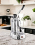 La Pavoni Stradivari Lusso lever espresso machine in chrome finish on marble kitchen countertop, featuring manual pressure control lever and steam wand for professional-grade coffee brewing at home