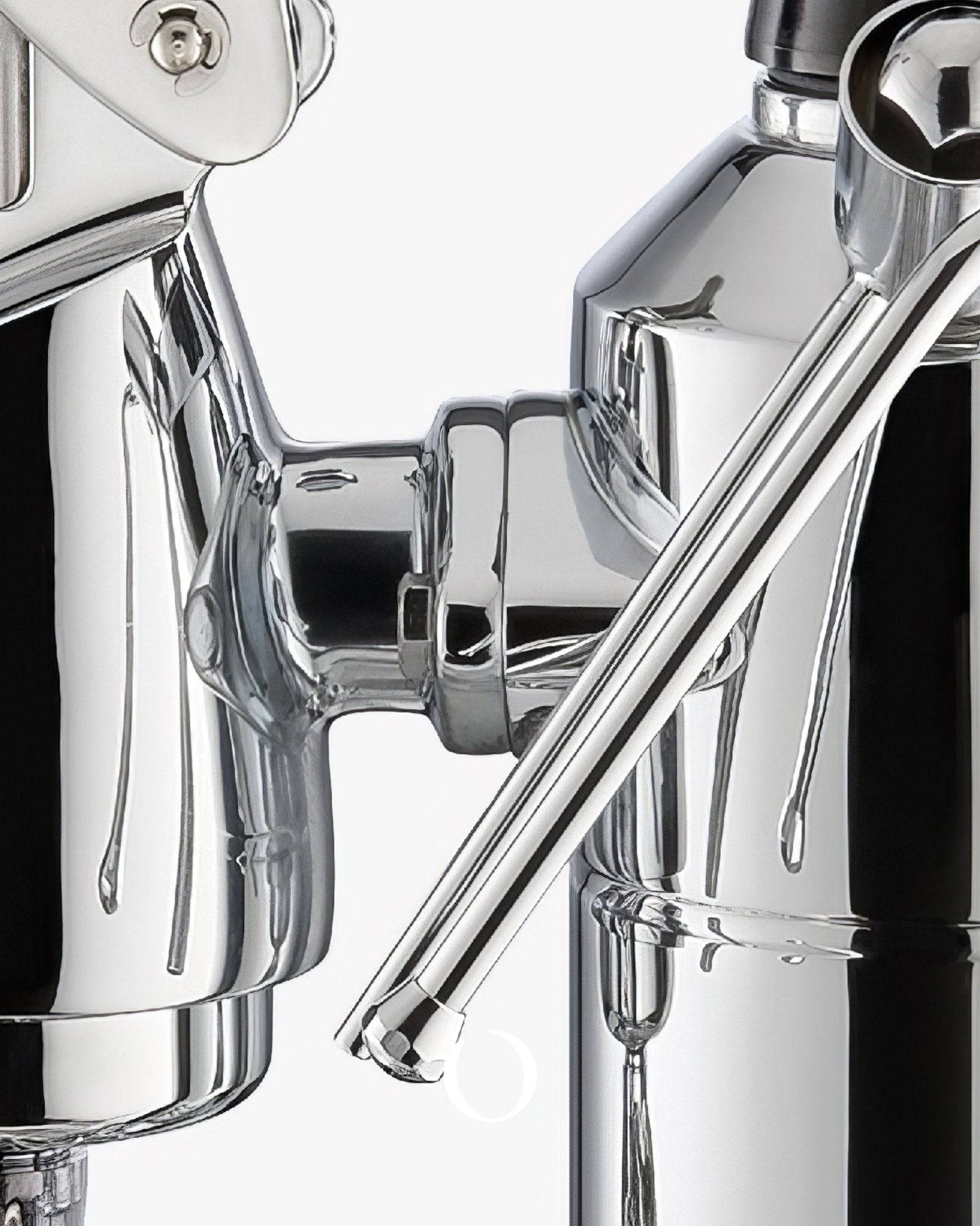 Close-up detail of La Pavoni Stradivari Lusso lever espresso machine, showing polished chrome components including boiler, group head, and steam wand, highlighting its elegant design and craftsmanship
