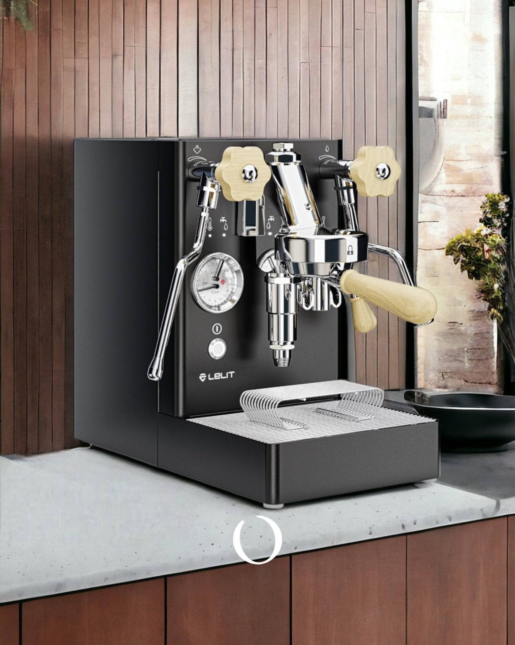 Lelit MaraX V2 espresso machine with black body, cream-colored knobs, pressure gauge, and steam wand, sitting on a concrete countertop against wooden paneled wall