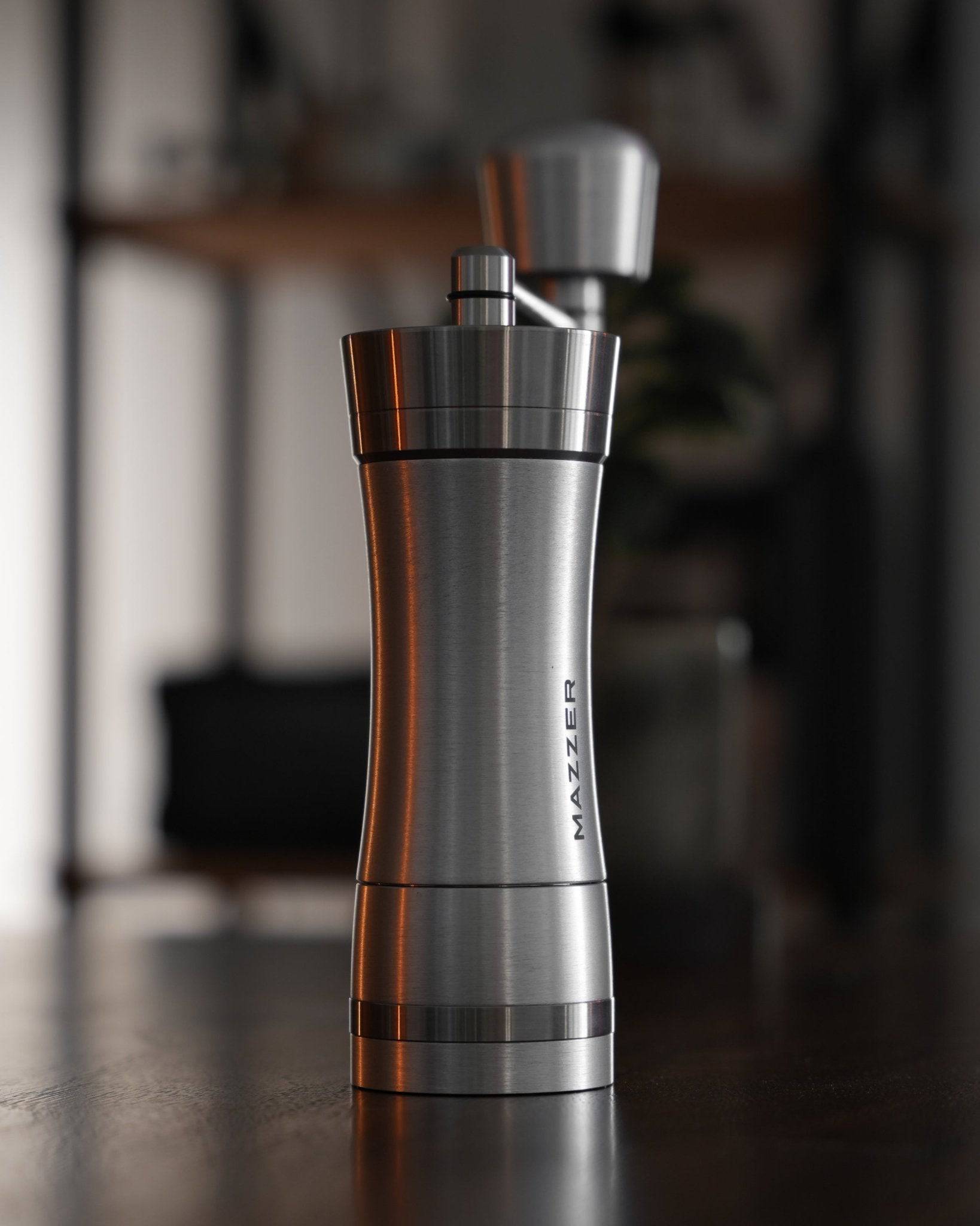 Mazzer Omega Soft manual coffee grinder, sleek stainless steel design with ergonomic handle, precision grinding mechanism for perfect coffee texture, compact and portable for home or travel use
