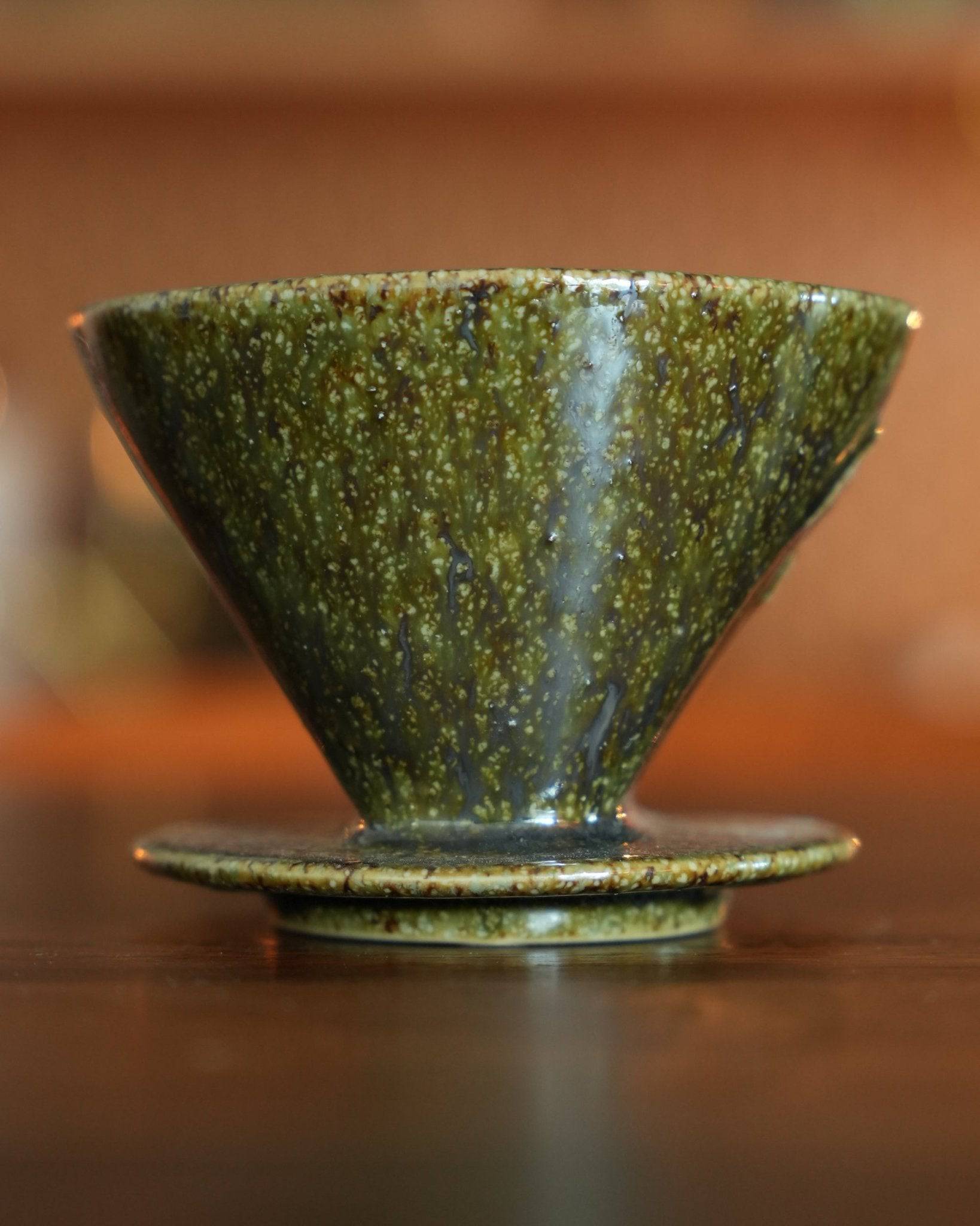 Melitta yellow-green ceramic pour-over coffee dripper with unique fan-shaped single hole design, made from high-quality Minoyaki pottery, showcasing traditional Japanese craftsmanship and modern elegance for optimal brewing experience