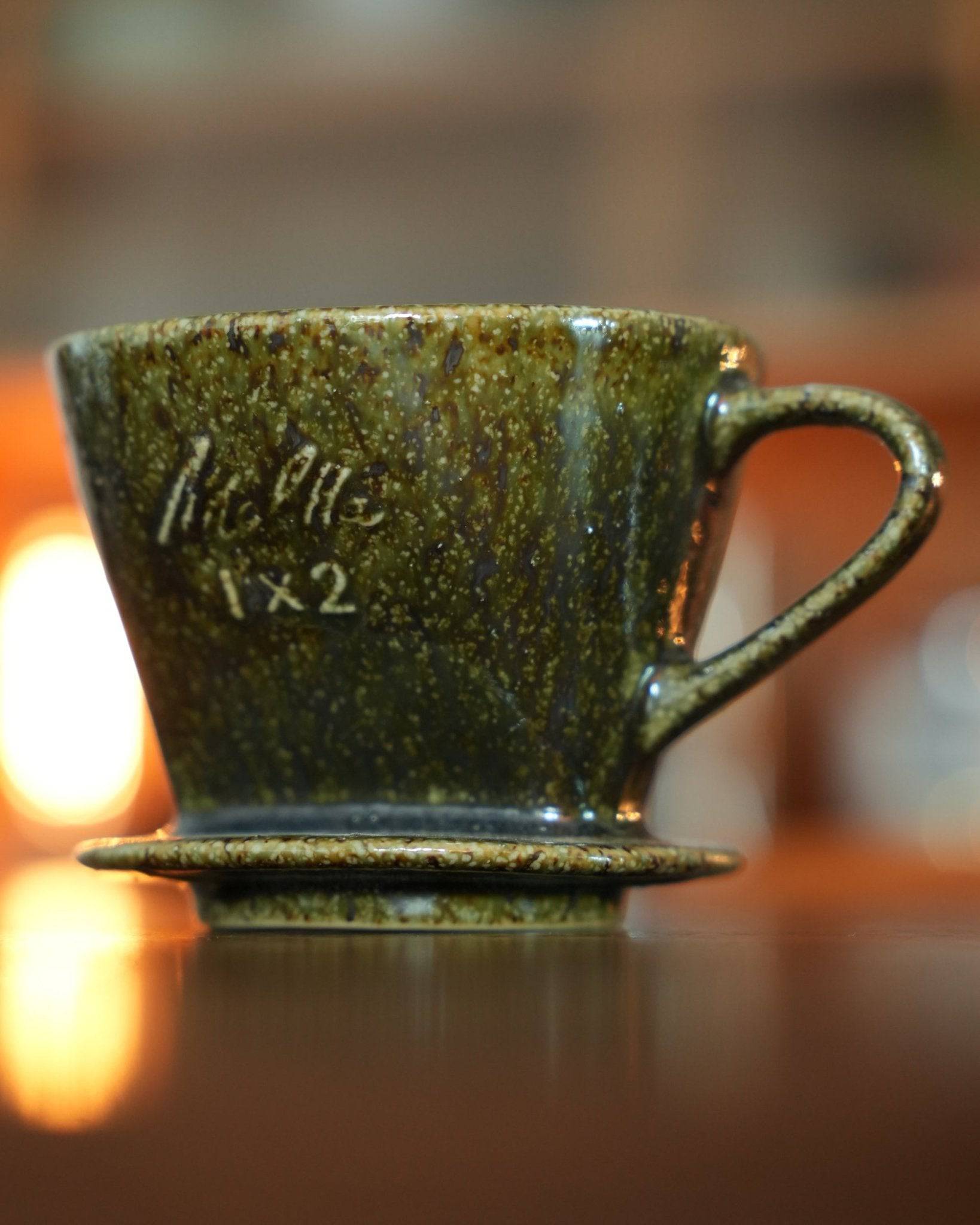 Melitta 1x2 ceramic pour-over coffee dripper in yellow-green glaze, showcasing traditional Minoyaki craftsmanship. Elegant fan-shaped design with single hole for optimal brewing. Limited edition color adds artistic value to home or office.